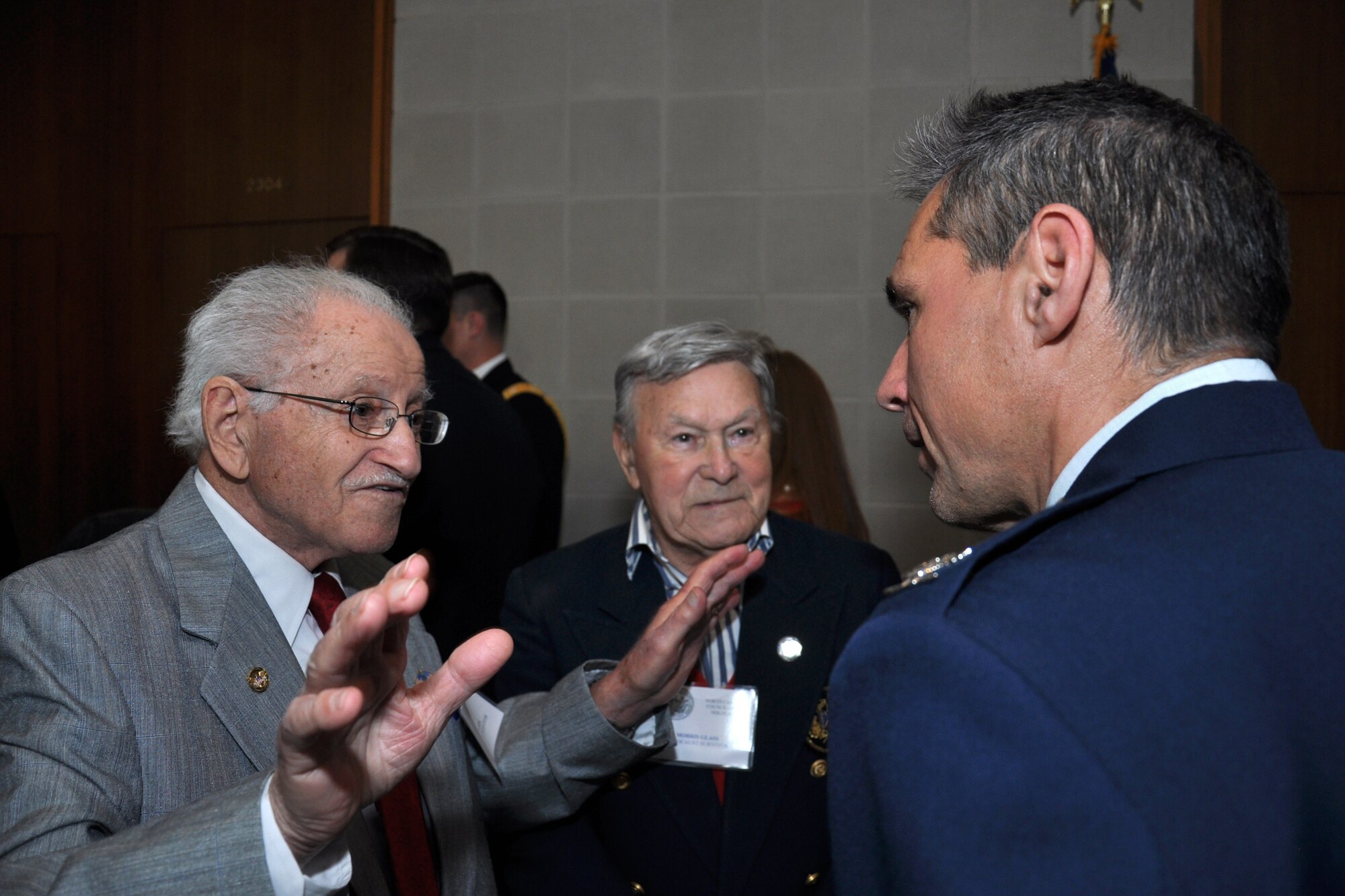 Col. Anthony Polashek, 916th Operations Group commander, speaks with Holocaust survivors who were imprisoned at Dachau concentration camp during World War II. Polashek and the Dachau survivors were in attendance at the North Carolina State Legislative building, April 29, 2015, for the passage of House Joint Resolution 668 by the State General Assembly, which honored Holocaust survivors and U.S. military veterans who aided in their liberation. (U.S. Air Force photo by Staff Sgt. Alan Abernethy)