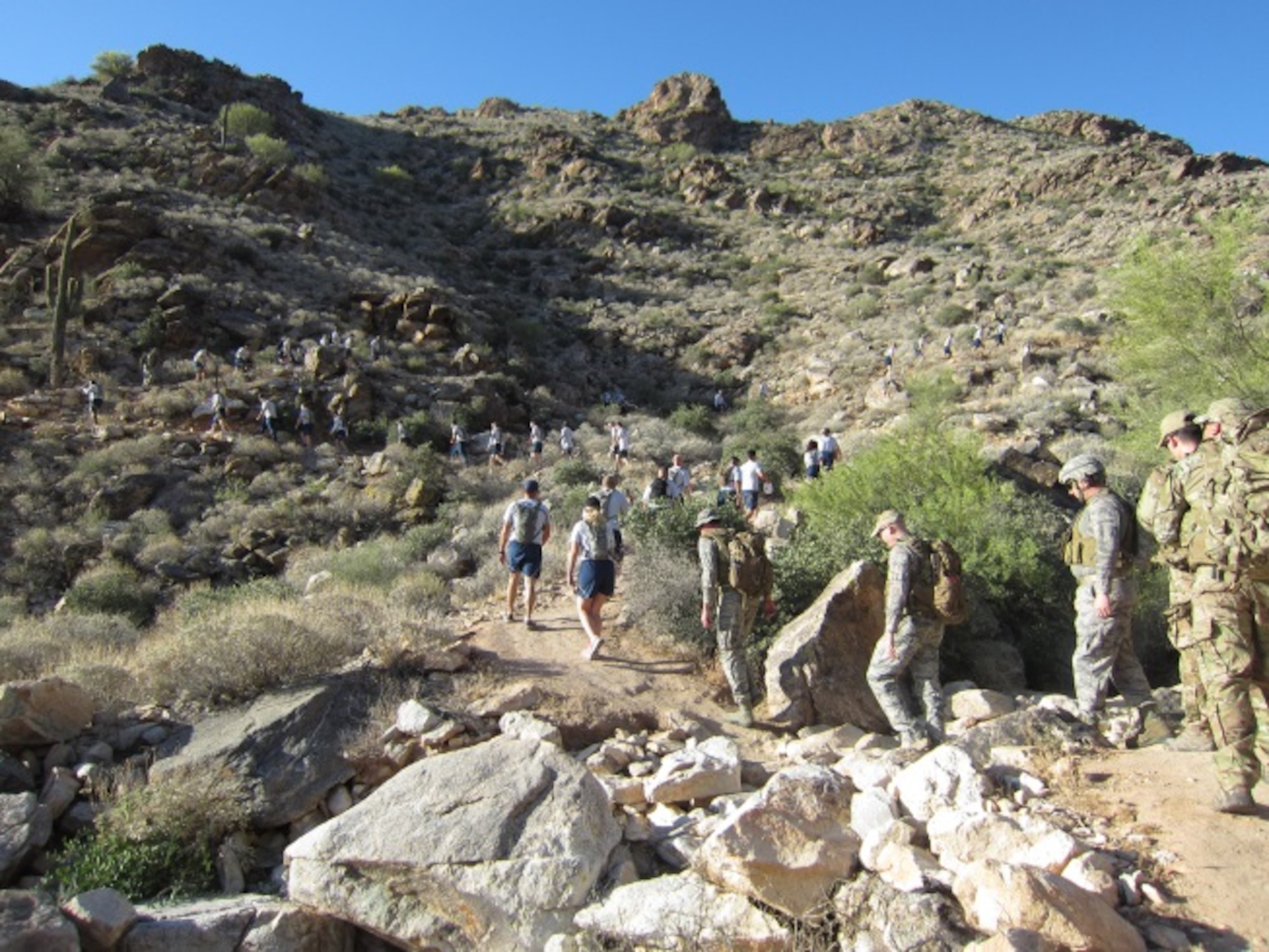 Members of the 944th Civil Engineer Squadron participate in a hike in the White Tank Mountains, Ariz. May 03, 2015.  The hike was designed to promote fitness and battlefield readiness for the squadron. (U.S. Air Force photo taken by Staff Sgt. Joshua Nason)