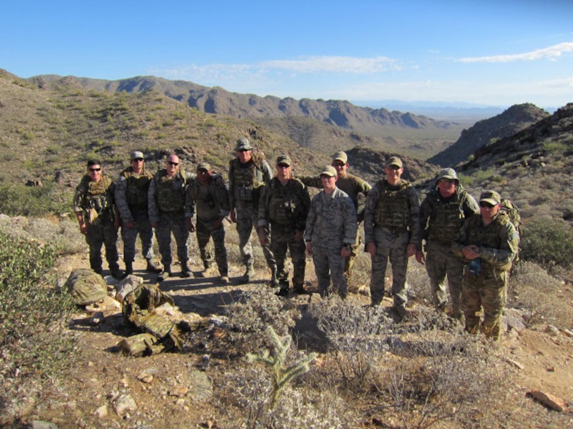 Members of the 944th Civil Engineer Squadron, Explosive Ordinance Disposal flight, pose for a group photo during a hike in the White Tank Mountains, Ariz. May 03, 2015.  All participating members from the EOD flight wore body armor, full uniform, and a weighted pack to upkeep battlefield readiness. (U.S. Air Force photo taken by Staff Sgt. Joshua Nason)