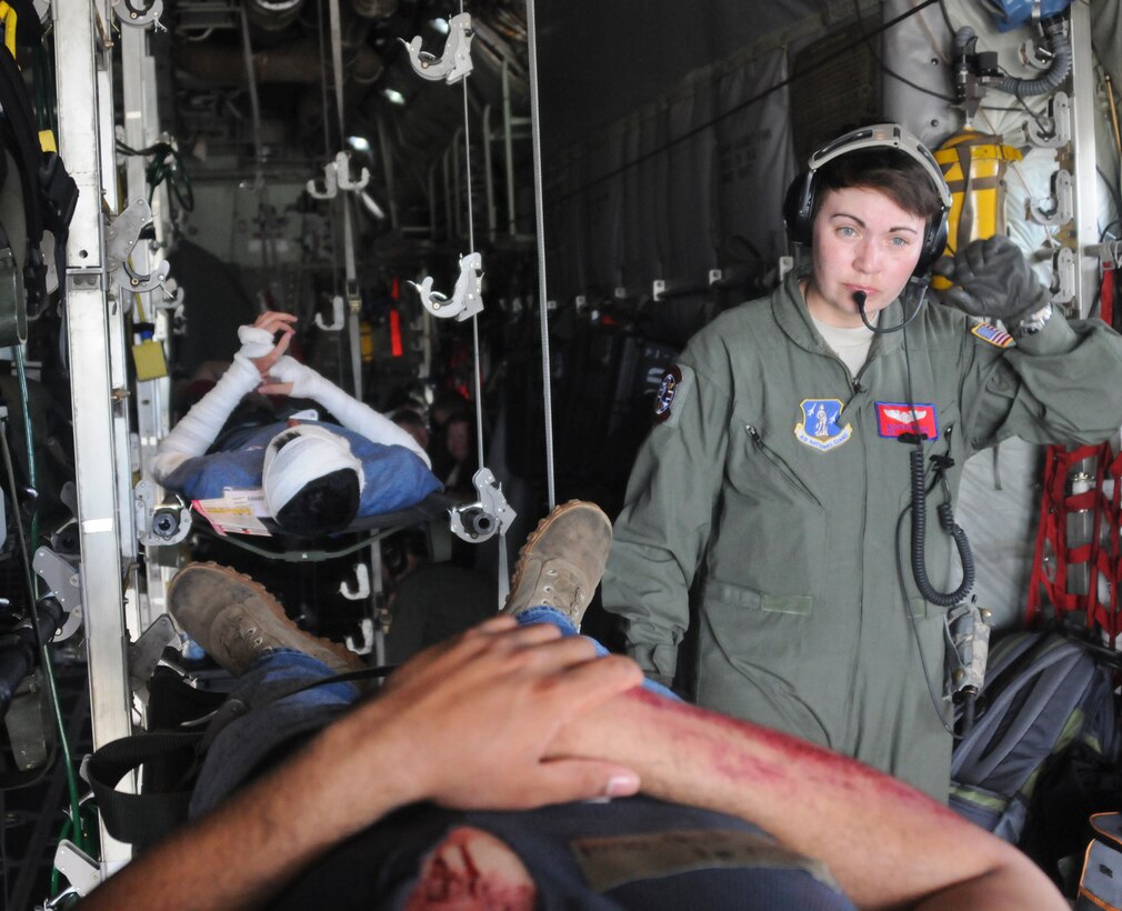 Senior Airman Heather Knighten, Aeromedical Evacuation Technician with the 137th Aeromedical Evacuation Squadron, observes critical patients before take-off on a C-130 during Air-X, simulated disaster relief training, April 24, 2015, in College Station, Texas.  The 137 AES was partnered with multiple military and government agencies in Texas to train for relief efforts during a hurricane scenario.  (U.S. Air Force photo by Airman 1st Class Brigette Waltermire).