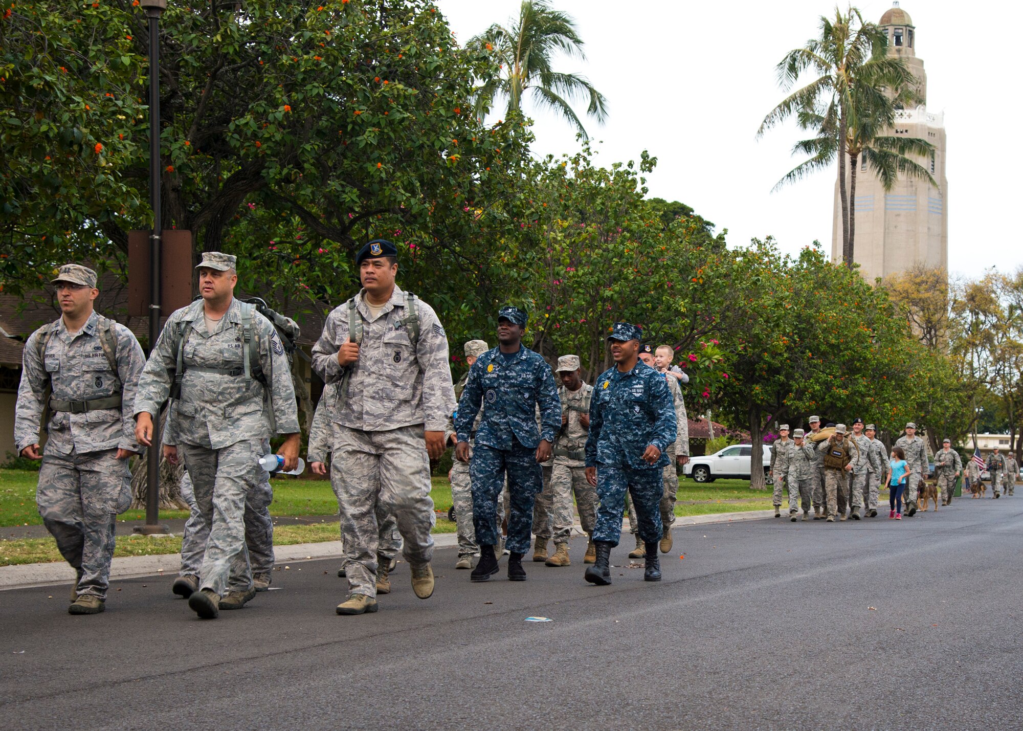 Airmen from the 647th Security Forces Squadron participate in a 2.5 mile ruck march to kick off Police Week on Joint Base Perl Harbor-Hickam, Hawaii, May 5, 2015. In 1962, President John F. Kennedy signed a proclamation that designated May 15th as Peace Officers Memorial Day and the week in which that date falls as Police Week. (U.S. Air Force Photo by Tech Sgt. Aaron Oelrich/Released) 