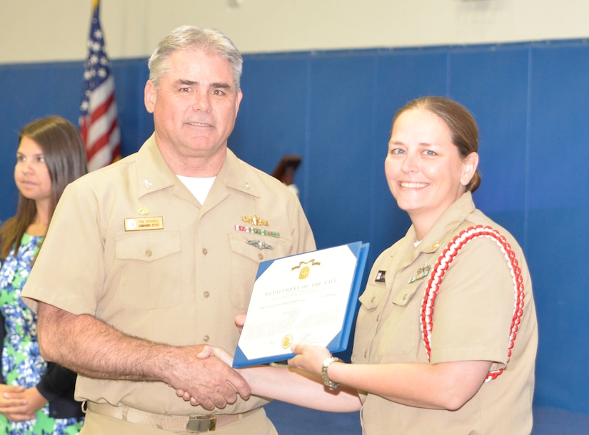 Captain Timothy Sparks, Joint Base Charleston deputy commander, presents the Navy Achievement Medal to ETCS Diane Lawson, Naval Nuclear Power Training Command, during the Sexual Assault Prevention and Response Program luncheon April 30, 2015 at Joint Base Charleston – Weapons Station, S.C. The Navy Achievement Medal was presented to Lawson for her dedicated to the SAPR program through volunteer hours, donations raised, victim response and education and awareness.  (U.S. Air Force photo/Seamus O’Boyle)