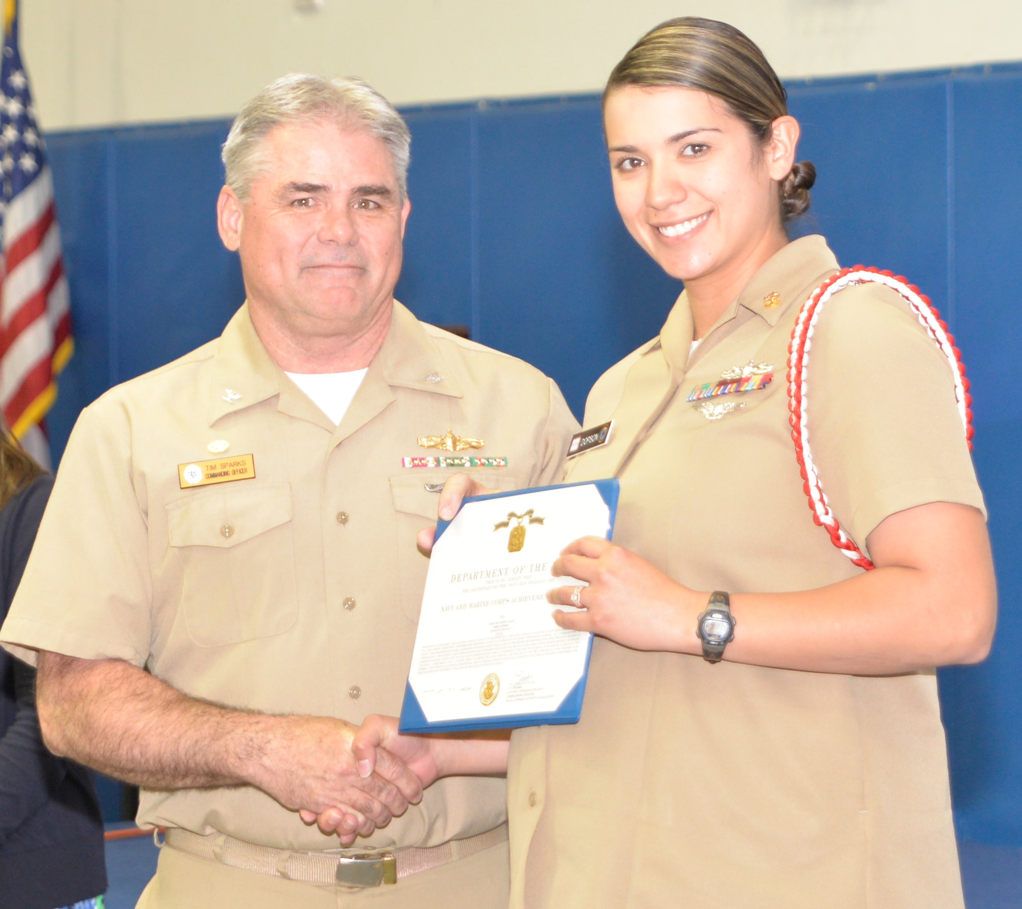 Captain Timothy Sparks, Joint Base Charleston deputy commander, presents the Navy Achievement Medal to MMC Erica Dopson, Naval Nuclear Power Training Command, during the Sexual Assault Prevention and Response Program luncheon April 30, 2015 at Joint Base Charleston – Weapons Station, S.C. The Navy Achievement Medals were presented to Dopson for her dedicated to the SAPR program through volunteer hours, donations raised, victim response and education and awareness. (U.S. Air Force photo/Seamus O’Boyle)