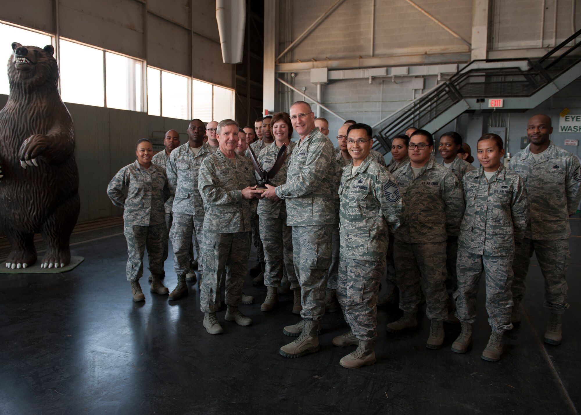 General Hawk Carlisle, commander of Air Combat Command, presents the 2014 Non-flying Logistics Readiness Squadron of the year to Maj. Ronald Boyd, 49th Materiel Maintenance Support Squadron commander, during his  visit at Holloman Air Force Base, N.M., May 8, 2015. Carlisle visited Holloman as a part of his first immersion  since taking command of ACC in Oct. 2014. During his visit he toured the base, met members of Team Holloman, and received a hands-on look at vast number of missions Holloman supports every day. (U.S. Air Force photo by Senior Airman Leah Ferrante/released)
