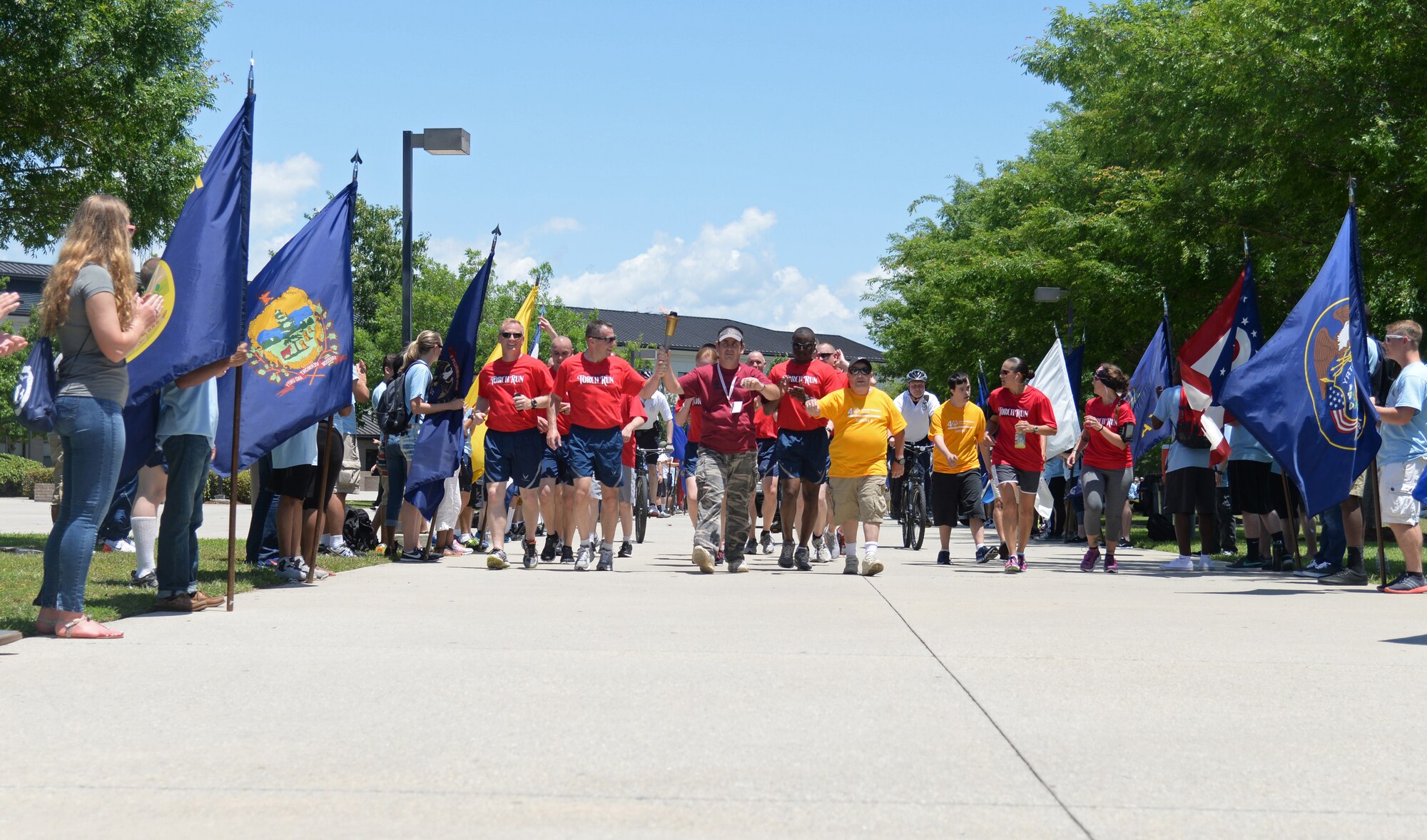 Airmen from the 81st Security Forces Squadron, 81st Training Wing leadership and Special Olympics athletes participate in the 2015 Law Enforcement Torch Run for Special Olympics, May 8, 2015, Keesler Air Force Base, Miss. Law enforcement officers from across Mississippi participated in the annual event to escort the Special Olympics Flame of Hope  to the opening ceremonies. (U.S. Air Force photo by Senior Airman Holly Mansfield)