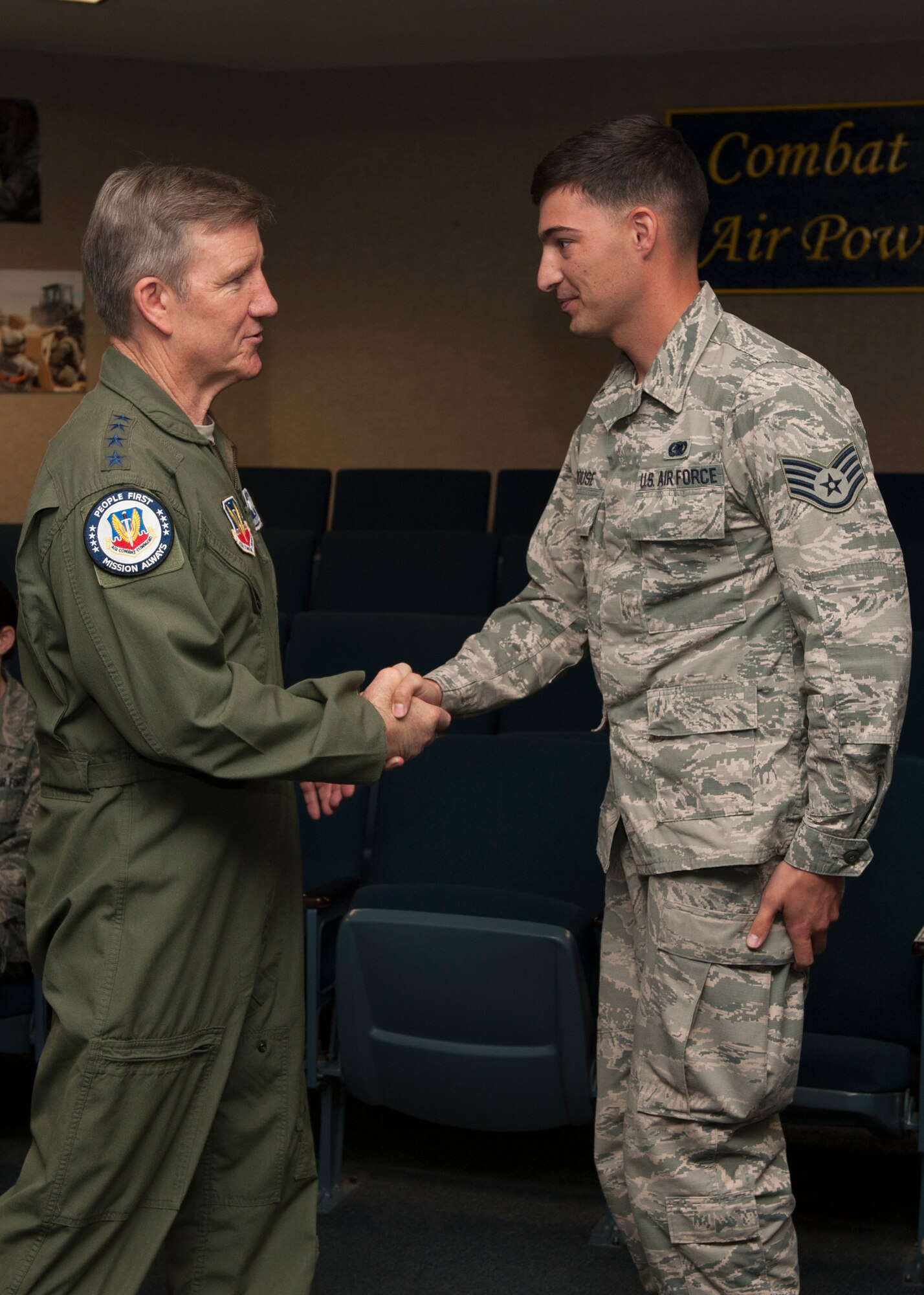 General Hawk Carlisle, commander of Air Combat Command, coins Staff Sgt. Joshua Sprouse, 49th Materiel Maintenance Support Squadron for being picked as one of Holloman’s top superior performers at Holloman Air Force  Base, N.M., May 8, 2015. Carlisle visited Holloman since taking command of ACC in Nov.  2014. During his visit he toured the base, met members of Team Holloman, and received a hands-on look at the vast number of missions Holloman’s Airmen support every day. (U.S. Air Force photo by Senior Airman Leah Ferrante/released)