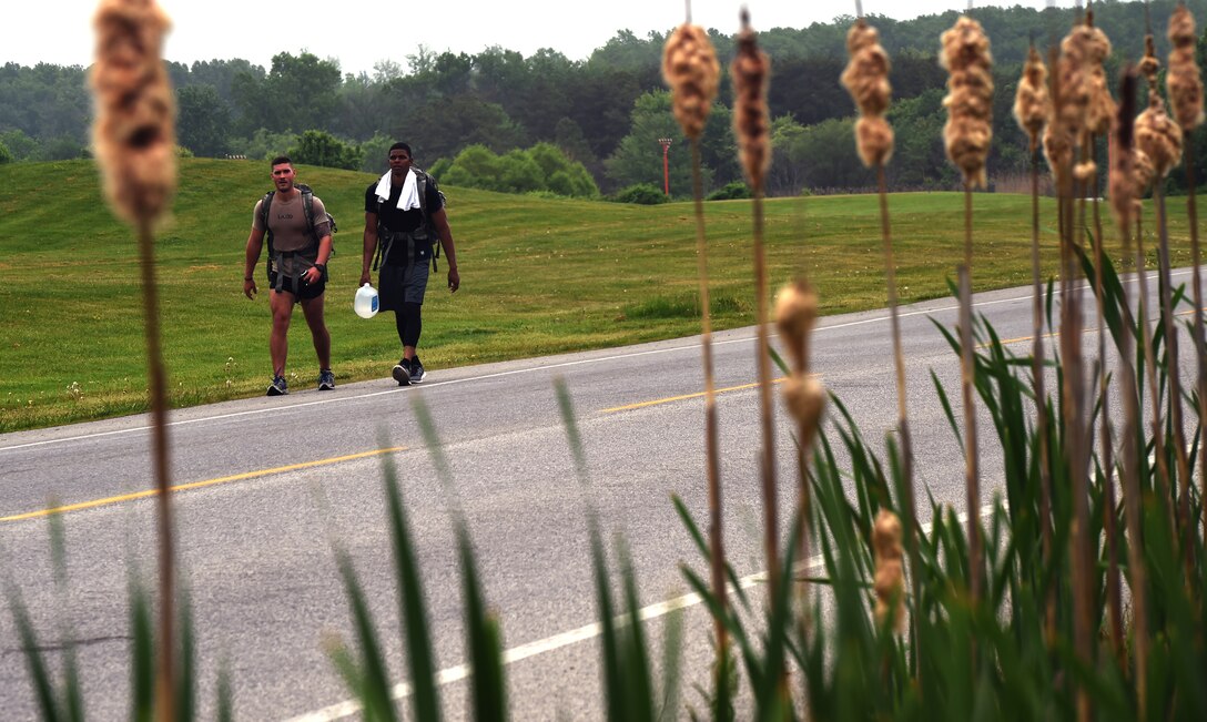 Airman 1st Class Skyler Ladd, (left) and Airman 1st Class James Peterson, (right) participate in an 8.2 mile ruck march on Joint Base Andrews, Md., May 11, 2015, during National Police Week. Approximately 35 security forces members participated in the ruck-march, where they were required to carry a ruck-sack weighing a minimum of 35 lbs. (U.S. Air Force photo by Senior Airman Mariah Haddenaham/Released)