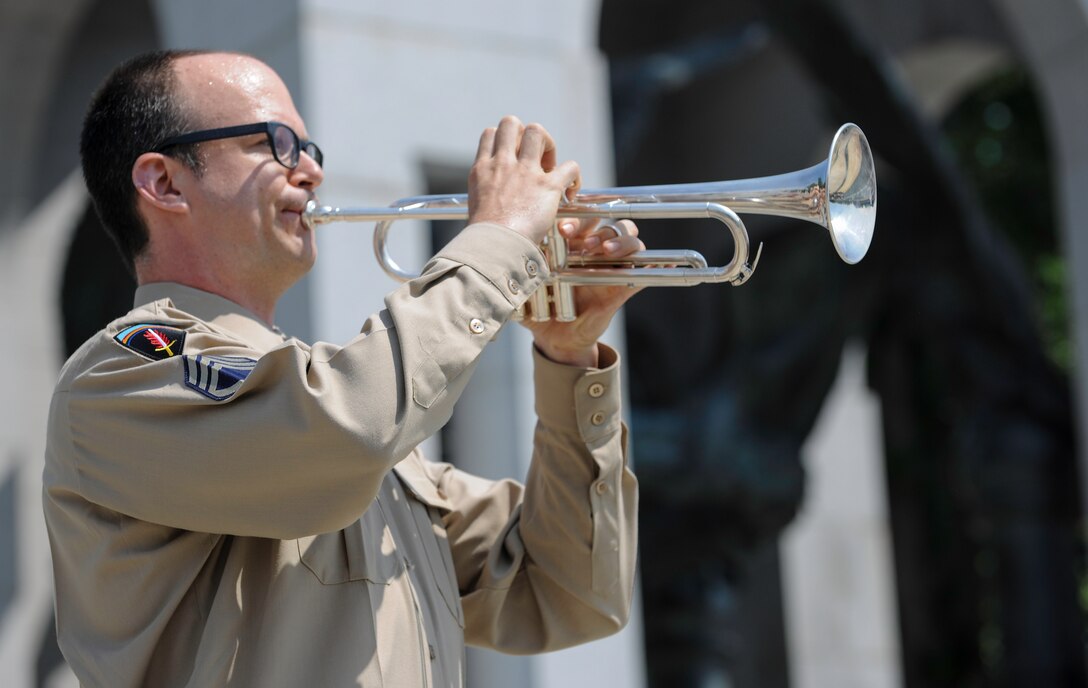 Tech. Sgt. Micah Killion, U.S. Air Force Band Airmen of Note trumpeter, plays “Taps” at the World War II Memorial in Washington D.C., May 8, 2015. The VE Day tribute included an Airmen of Note performance, guest speakers and a wreath laying by World War II veterans. (U.S. Air Force photo/Airman 1st Class J.D. Maidens)