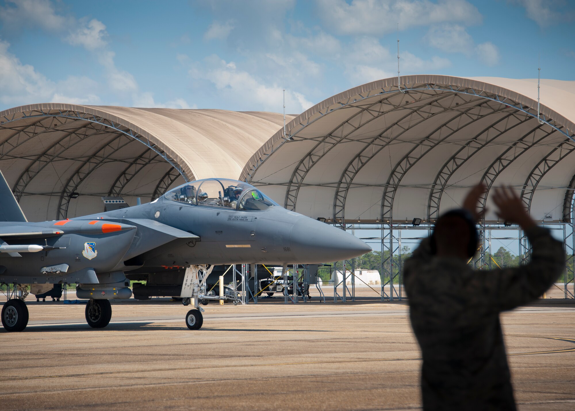 A crew chief marshalls in an F-15E Strike Eagle as part of an incentive flight May 7 at Eglin Air Force Base, Fla. Whitney Smith, the 53rd Wing honorary commander, had the opportunity to fly in an F-15 piloted by Maj. William Wooten, of the 85th Test and Evaluation Squadron. This was the first incentive flight awarded to a 53rd Wing honorary commander in more than three years. The 53rd Wing’s honorary commander program allows local community members a unique opportunity to interact with and learn about 53rd Wing Airmen, their mission and the role they play in supporting the Air Force. (U.S. Air Force photo/Sara Vidoni)