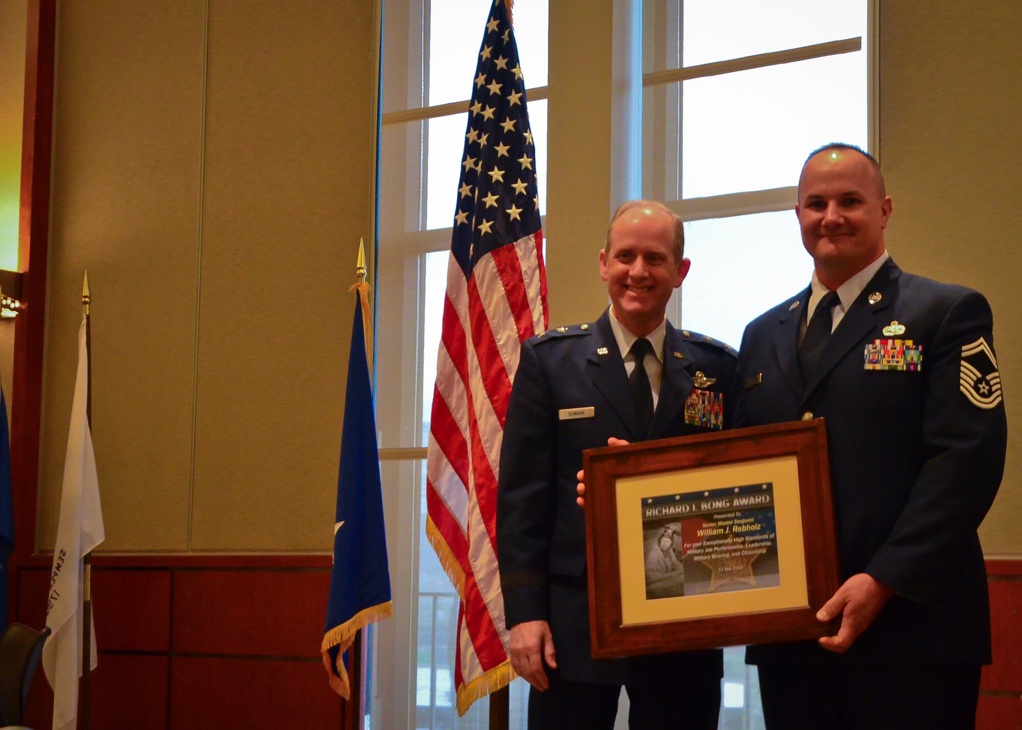 Senior Master Sgt. William J. Rebholz, an Airman with the 128th Air Refueling Wing, Wisconsin Air National Guard, receives the Richard I. Bong Award and poses with Maj. Gen. Donald Dunbar, Wisconsin adjutant general, at the ESGR Breakfast with the Boss event at the Milwaukee County Wary Memorial May 11, 2015.  The award is given by the Milwaukee Armed Services Committee to service members who have displayed outstanding skill, dedication, and professionalism on and off duty.  (U.S. Air National Guard photo by Tech. Sgt. Jenna Lenski/Released)