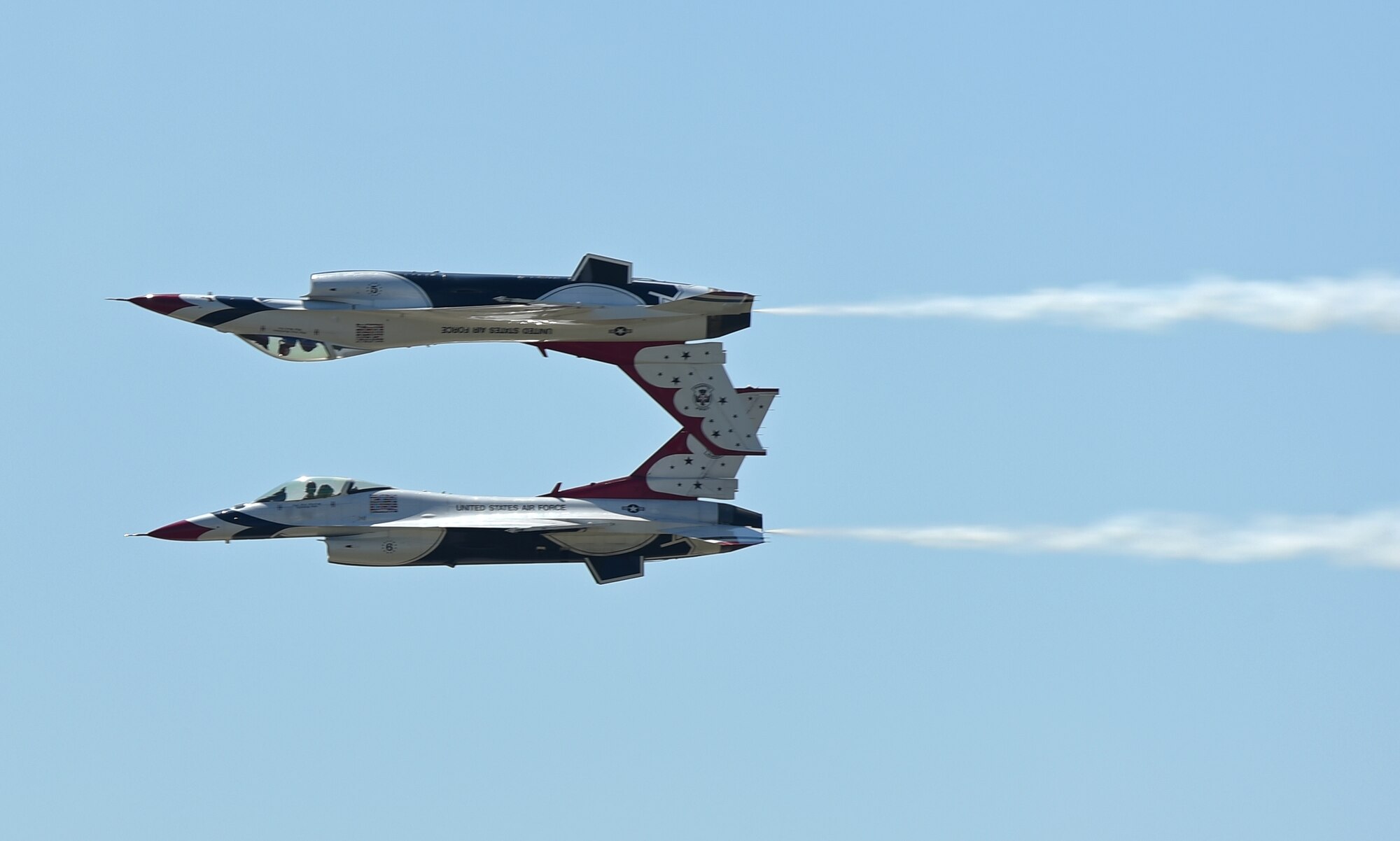 Two F-16E Fighting Falcons fly in a mirror image formation during the Dyess Big Country Airfest May 2, 2015, at Dyess Air Force Base, Texas. This year’s Airfest was an especially big event as it coincided with the 30th anniversary of the first B-1B delivered to Dyess, and celebrated 60 years since the C-130 was first presented to the Air Force. The Thunderbirds flew both Saturday and Sunday for crowds that totaled more than 26,000 spectators. (U.S. Air Force photo by Senior Airman Peter Thompson/Released)