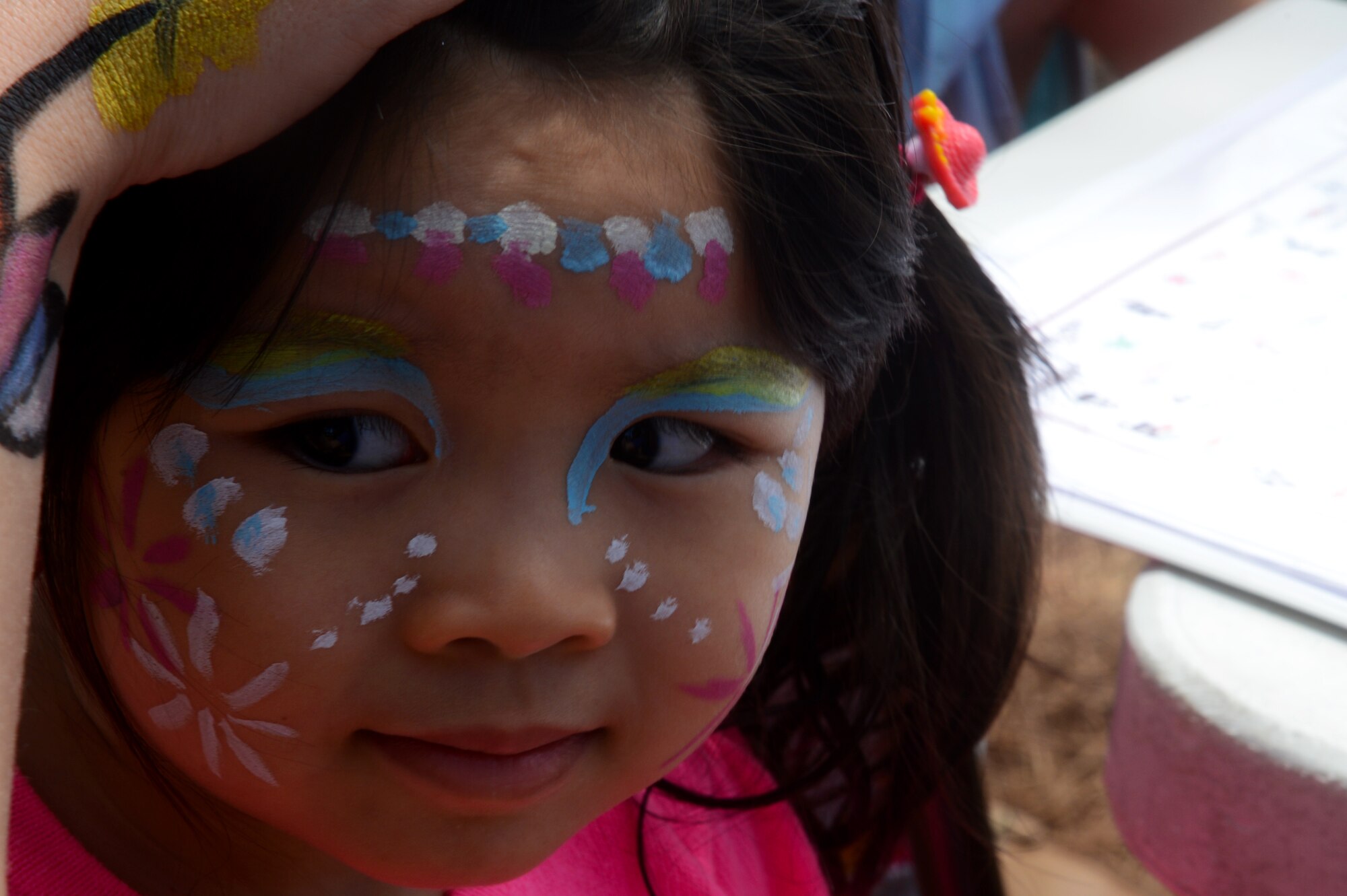 A child has her face painted during “Big A” day at Shaw Air Force Base, S.C., May 8, 2015. Throughout the day, face painting, bouncy castles, corn-hole, and food were provided for Airmen and their families. (U.S. Air Force photo by Senior Airman Jonathan Bass/Released)