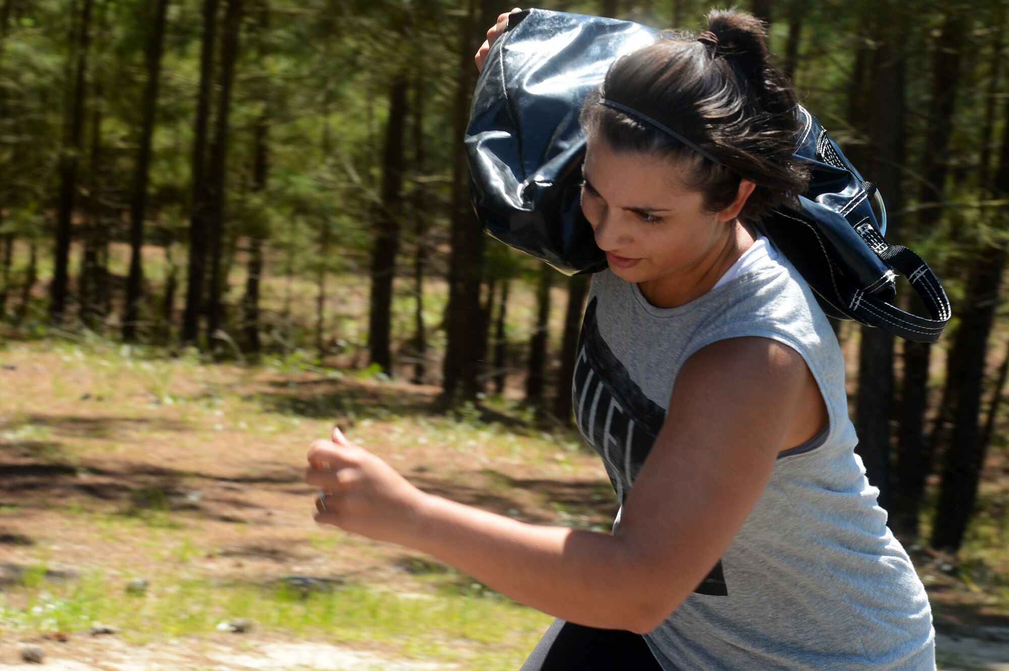 U.S. Air Force Senior Airman Diana Cossaboom, 20th Fighter Wing public affairs photojournalist, carries a sandbag during the “Airman Up Challenge” as part of “Big A” day at Shaw Air Force Base, S.C., May 8, 2015. The “Airman Up Challenge” was a seven obstacle course consisting of a sand bag carry, push-up ladder, blind walk, and more obstacles Airmen had to accomplish. (U.S. Air Force photo by Senior Airman Jonathan Bass/Released)