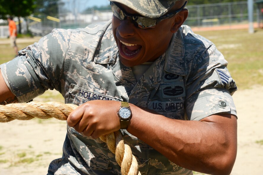 U.S. Air Force Staff Sgt. Kenny Holston, 20th Fighter Wing public affairs NCO-in charge of training, yells as he instructs his team to pull during “tug-of-war” at a “Big A” Day event at Shaw Air Force Base, S.C., May 8, 2015. Throughout the day, face painting, bouncy castles, corn-hole, and food were provided for Airmen and their families. (U.S. Air Force photo by Senior Airman Jonathan Bass/Released)