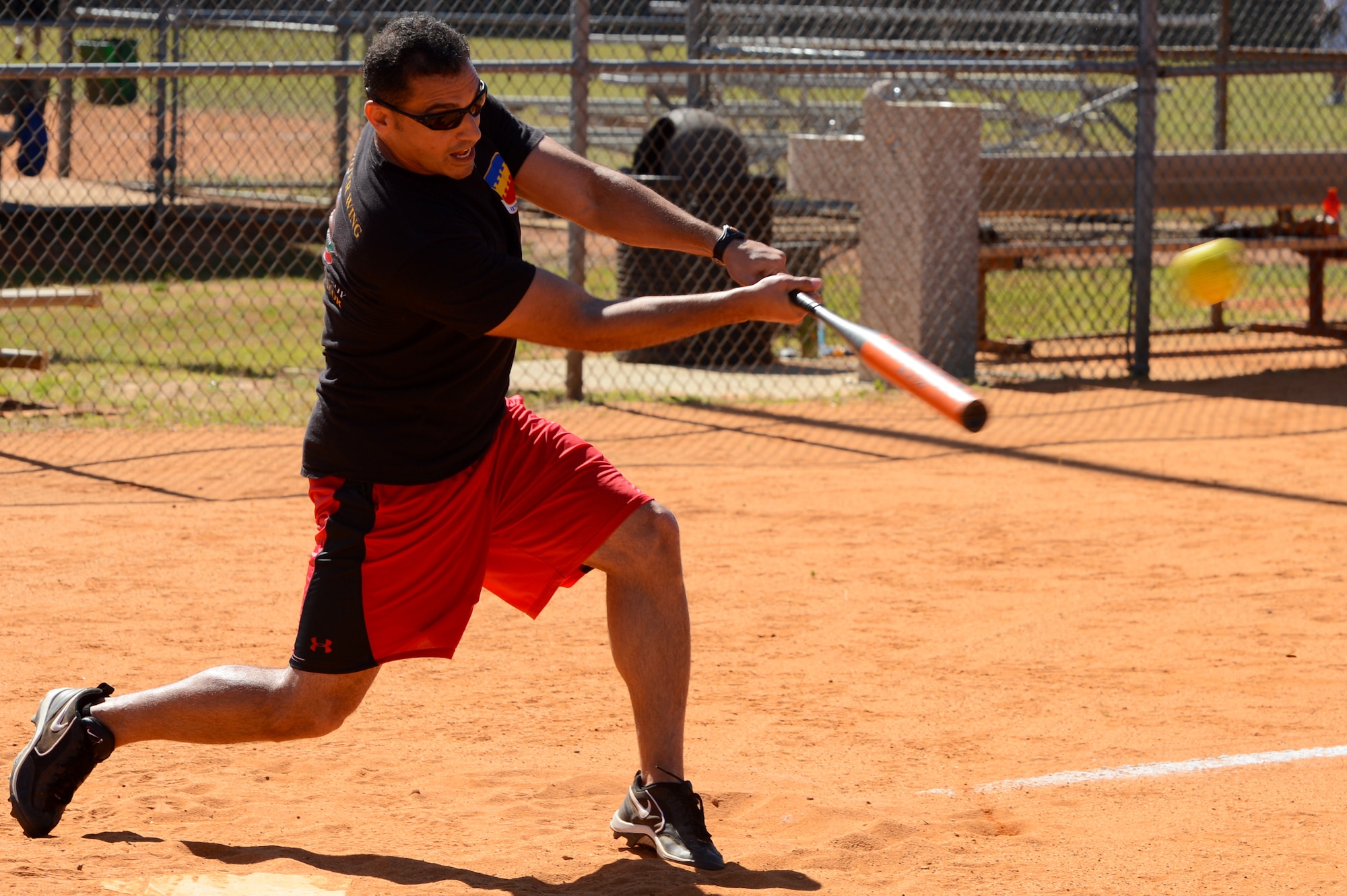U.S. Air Force Lt. Col. Jorge Jimenez, 20th Comptroller Squadron commander, hits a softball during the “Chiefs” verses “Eagles” softball game at a “Big A” day event at Shaw Air Force Base, S.C., May 8, 2015. Jimenez hit an inside the park home run, bringing home four runs in the process. (U.S. Air Force photo by Senior Airman Jonathan Bass/Released)