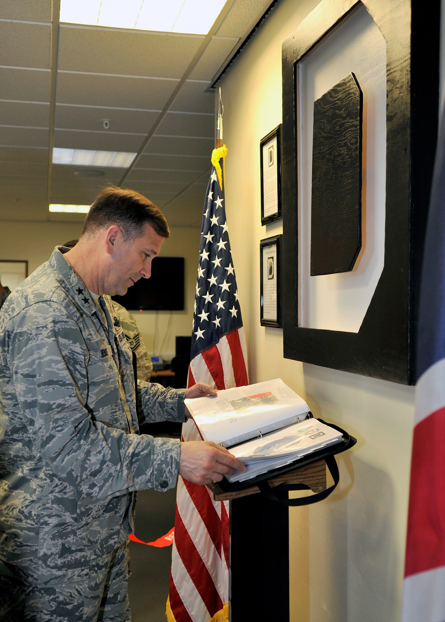 U.S. Air Force Maj. Gen. Christopher Bence, 3rd Air Force and 17th Expeditionary Air Force vice commander, admires a RAF Mildenhall Square D heritage display May 7, 2015, on RAF Mildenhall, England. Bence and U.S. Air Force Chief Master Sgt. Kaleth Wright, 3rd AF and 17th EAF command chief master sergeant, visited multiple base units to gain insight on the different missions and daily operations. (U.S. Air Force photo by Airman 1st Class Kyla Gifford/Released)