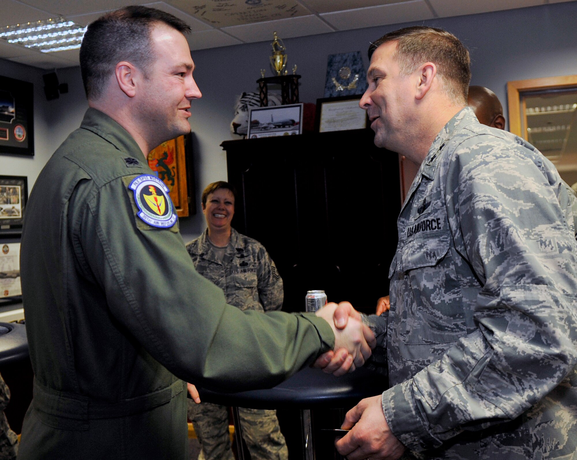 U.S. Air Force Maj. Gen. Christopher Bence, right, 3rd Air Force and 17th Expeditionary Air Force vice commander, thanks U.S. Air Force Lt. Col. Michael Parks, 351st Air Refueling Squadron commander, after receiving the 100th Bomb Group heritage patch May 7, 2015, on RAF Mildenhall, England. Bence and U.S. Air Force Chief Master Sgt. Kaleth Wright, 3rd AF and 17th EAF command chief master sergeant, visited multiple base units gaining insight on the different missions and daily operations. (U.S. Air Force photo by Airman 1st Class Kyla Gifford/Released)