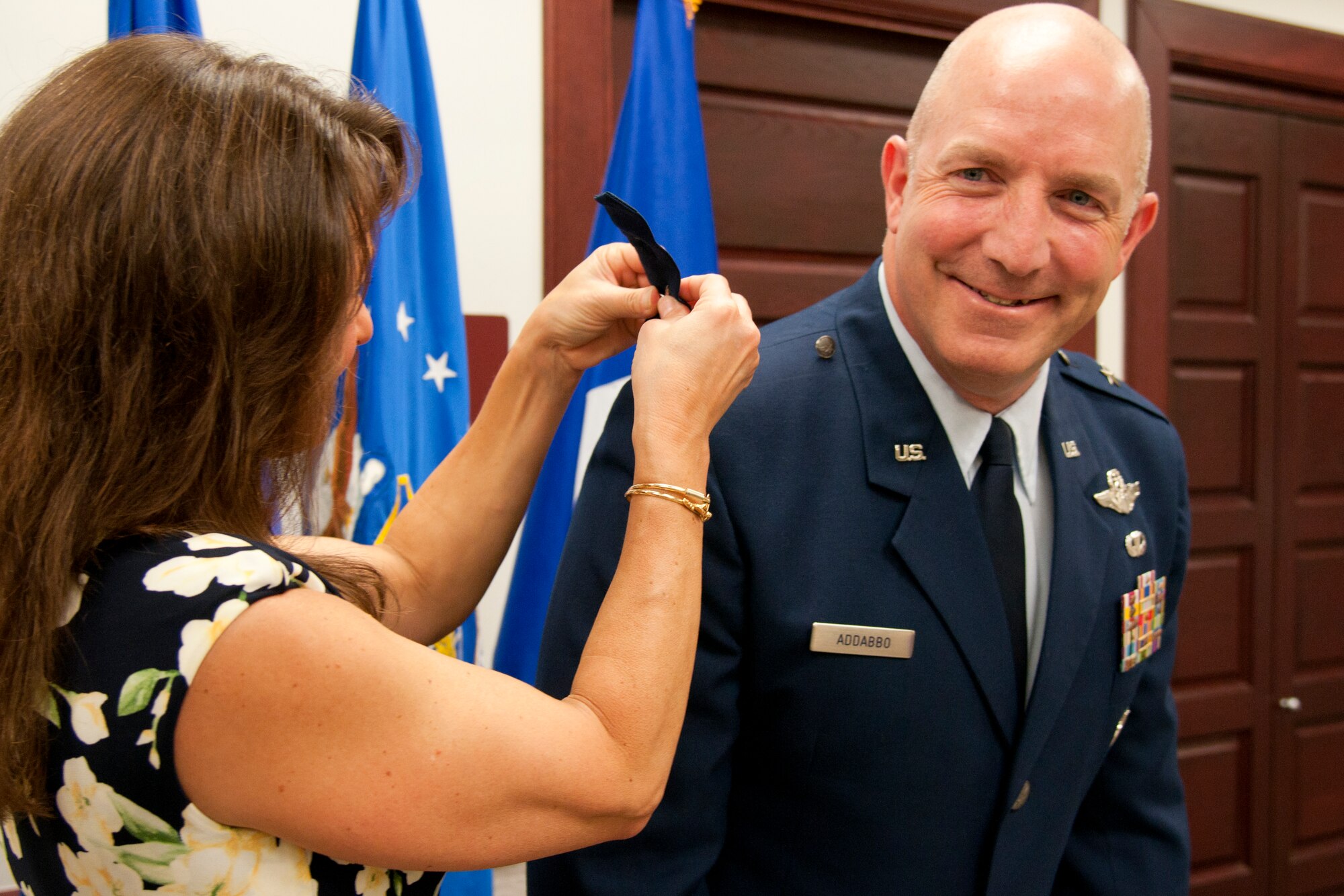 Kris Addabbo pins the brigadier general rank on her husband, Brig. Gen. Vito Addabbo, 20th Air Force and Task Force-214 mobility assistant, during his promotion ceremony May 7, 2015, in 20th AF Headquarters on F.E. Warren Air Force Base, Wyo. Addabbo holds responsibility for assisting the 20th AF commander in the management of the nation’s ICBM force. (U.S. Air Force photo by Airman 1st Class Malcolm Mayfield)