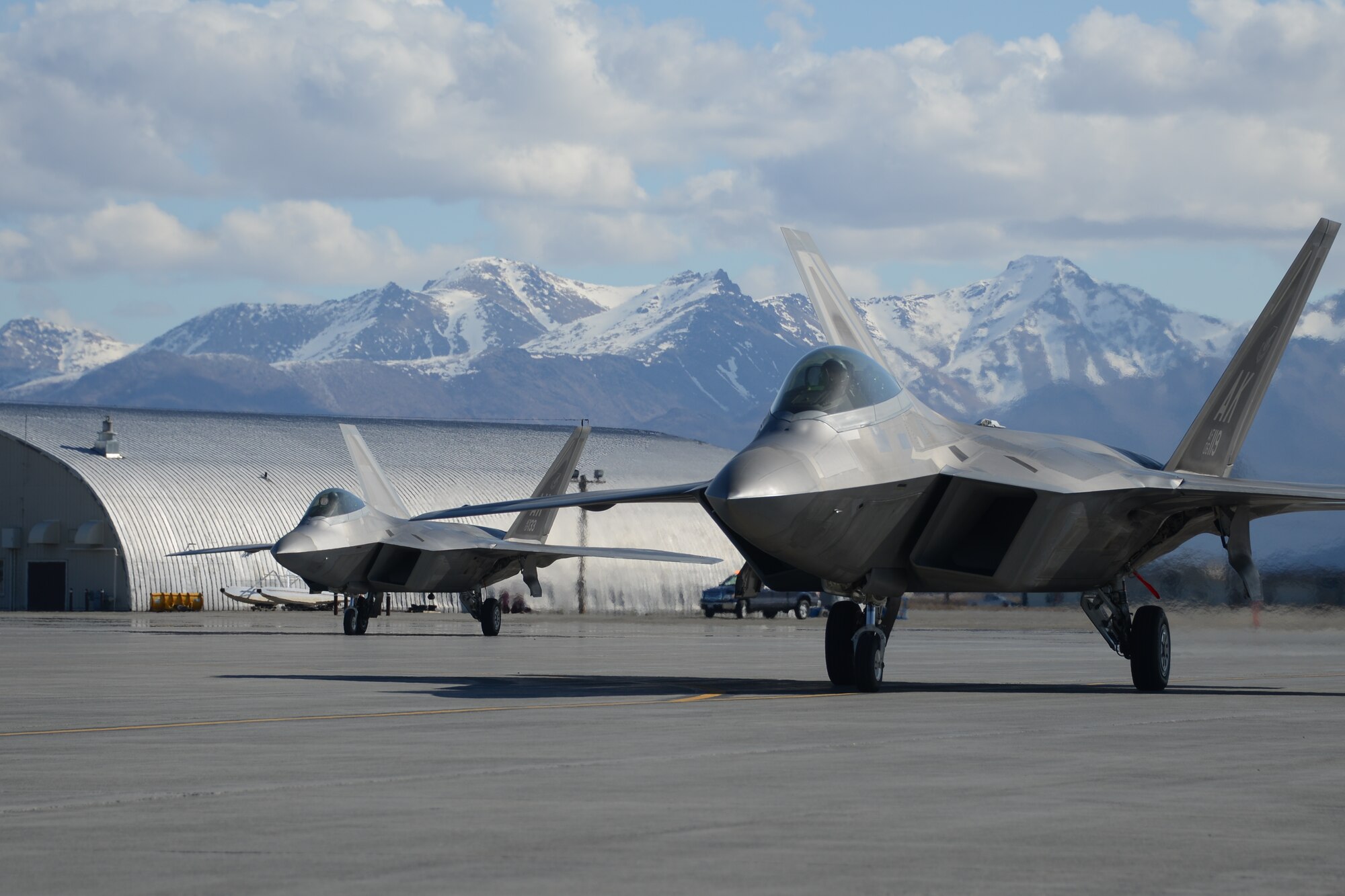 Airmen from the 477th Aircraft Maintenance Squadron perform a hot-pit refuel with an F-22 here May 2. Hot-pitting is the quickest way to perform the most sorties and is the key to mission combat capability. During a hot-pit refuel the pilot will stay in the cockpit with the jet running while the maintenance crews perform safety checks and refuel the aircraft allowing it to return to flight in less than 30 minutes. (U.S. Air Force photo/Tech. Sgt. Dana Rosso)
