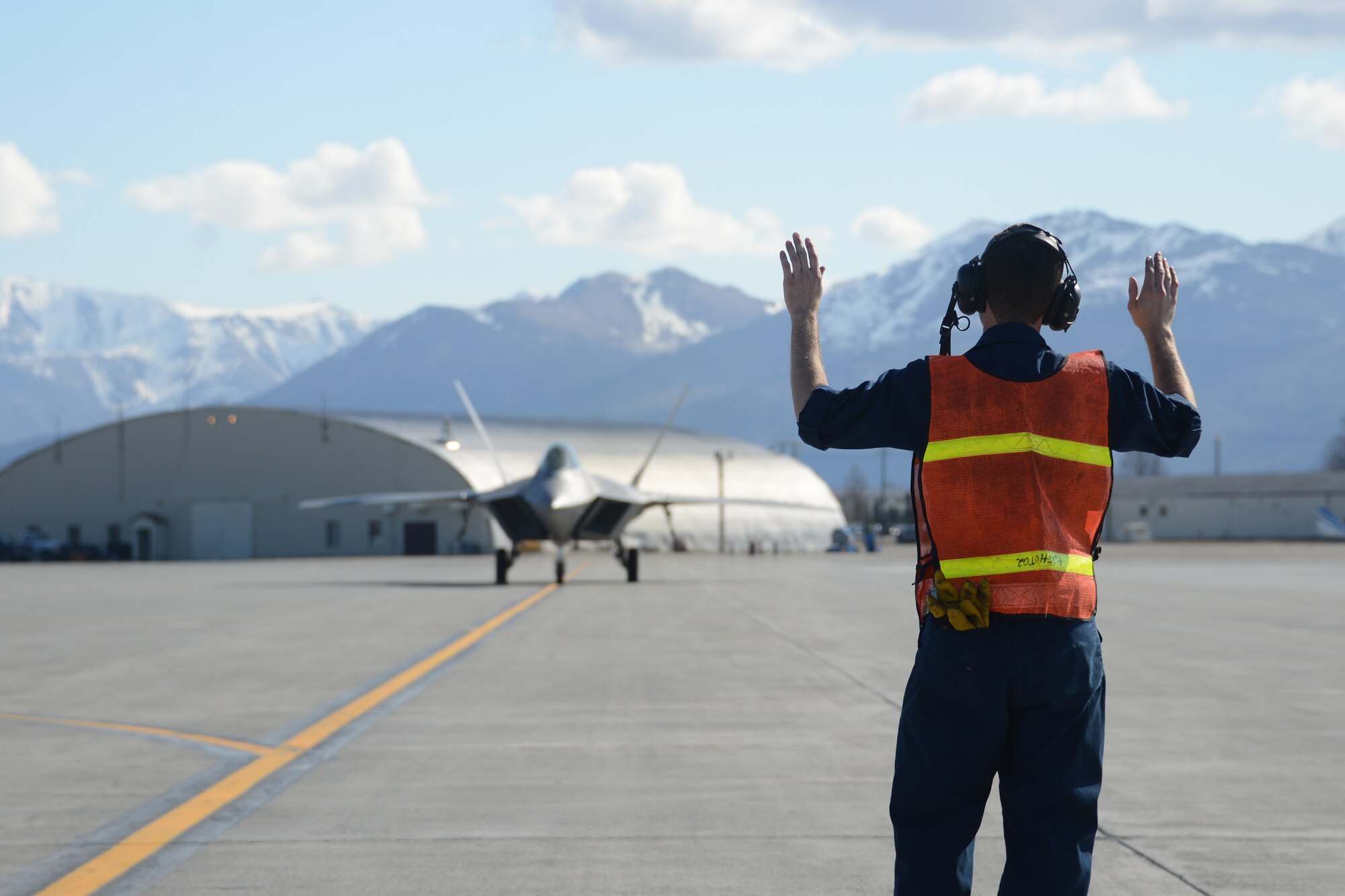Airmen from the 477th Aircraft Maintenance Squadron perform a hot-pit refuel with an F-22 here May 2. Hot-pitting is the quickest way to perform the most sorties and is the key to mission combat capability. During a hot-pit refuel the pilot will stay in the cockpit with the jet running while the maintenance crews perform safety checks and refuel the aircraft allowing it to return to flight in less than 30 minutes. (U.S. Air Force photo/Tech. Sgt. Dana Rosso)

