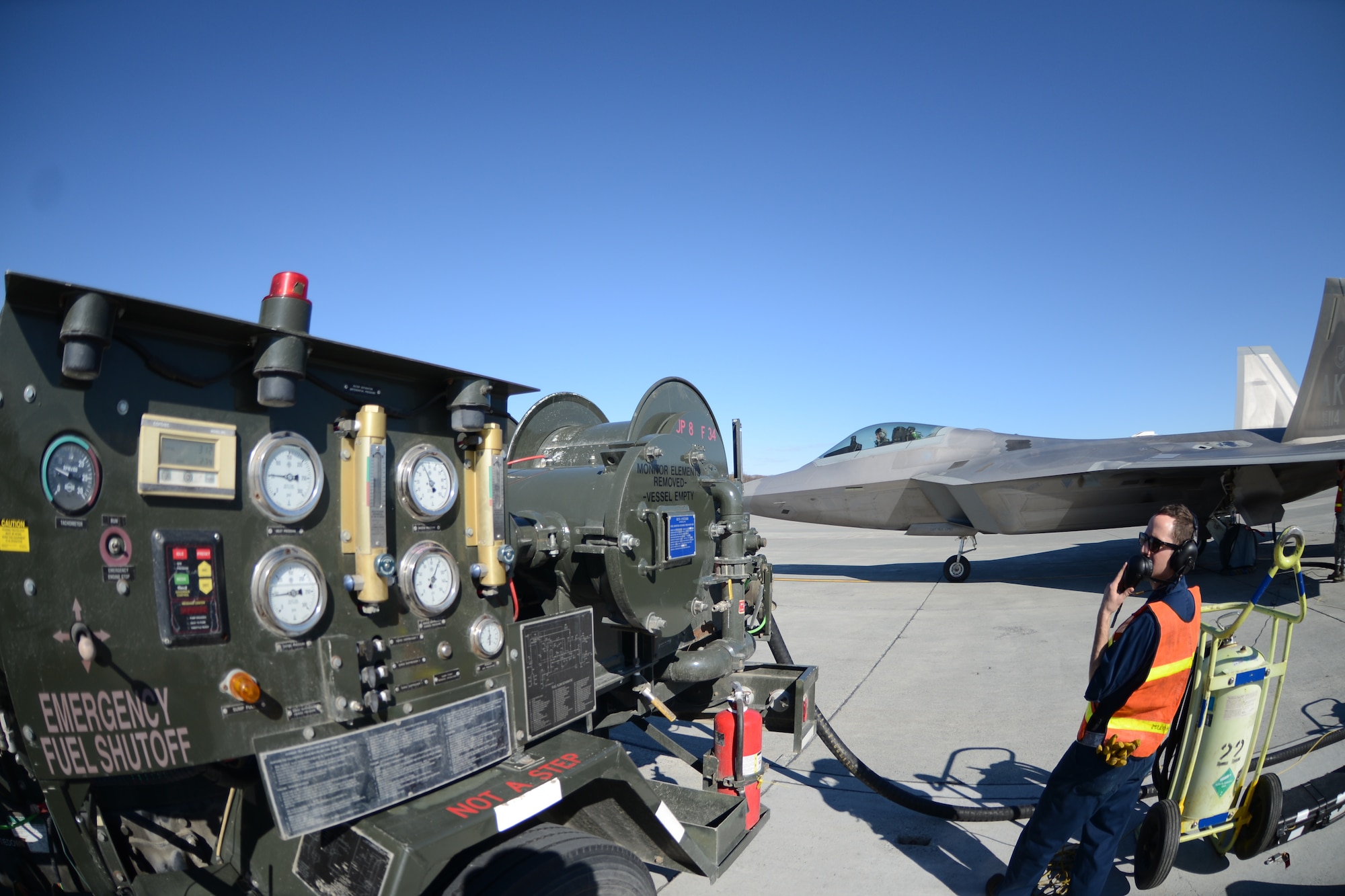 Airmen from the 477th Aircraft Maintenance Squadron perform a hot-pit refuel with an F-22 here May 2. Hot-pitting is the quickest way to perform the most sorties and is the key to mission combat capability. During a hot-pit refuel the pilot will stay in the cockpit with the jet running while the maintenance crews perform safety checks and refuel the aircraft allowing it to return to flight in less than 30 minutes. (U.S. Air Force photo/Tech. Sgt. Dana Rosso)
