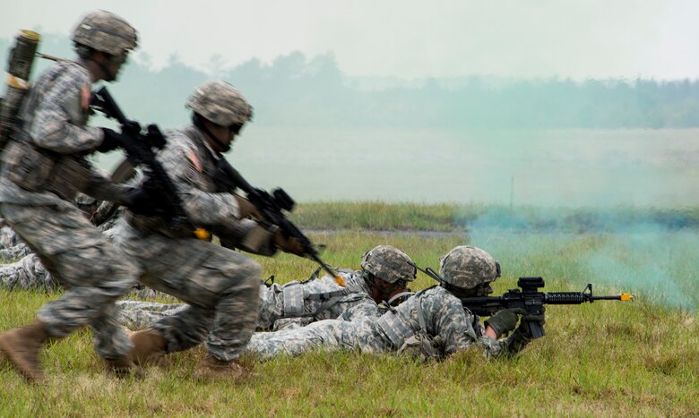 A team of Rangers enters the field through smoke during a demonstration at the 6th Ranger Training Battalion’s Open House event May 9 at Eglin Air Force Base, Fla. The event was a chance for the public to learn how Rangers train and operate. The event displays showed equipment, weapons, a reptile zoo, face painting and weapon firing among others. The demonstrations showed off hand-to-hand combat, a parachute jump, snake show, and Rangers in action. (U.S. Air Force photo/Tech. Sgt. Jasmin Taylor)