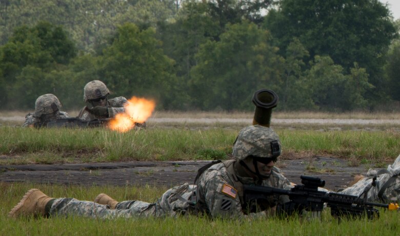 Teams of Rangers enter the field with gun fire during a demonstration at the 6th Ranger Training Battalion’s Open House event May 9 at Eglin Air Force Base, Fla. The event was a chance for the public to learn how Rangers train and operate. The event displays showed equipment, weapons, a reptile zoo, face painting and weapon firing among others. The demonstrations showed off hand-to-hand combat, a parachute jump, snake show, and Rangers in action. (U.S. Air Force photo/Tech. Sgt. Jasmin Taylor)