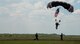 Members of the parachute team help a soldier as he lands during a demonstration at the Rangers’ Open House event May 9 at Eglin Air Force Base, Fla. The event was a chance for the public to learn how Rangers train and operate. The event displays showed equipment, weapons, a reptile zoo, face painting and weapon firing among others. The demonstrations showed off hand-to-hand combat, a parachute jump, snake show, and Rangers in action. (U.S. Air Force photo/Tech. Sgt. Jasmin Taylor)