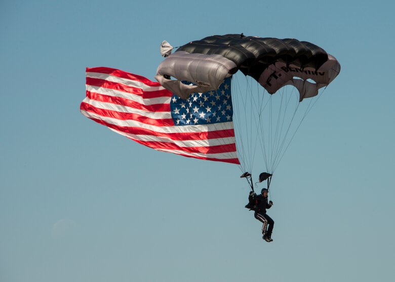 A soldier performs parachute jump procedures during a demonstration at the Rangers’ Open House event May 9 at Eglin Air Force Base, Fla. The event was a chance for the public to learn how Rangers train and operate. The event displays showed equipment, weapons, a reptile zoo, face painting and weapon firing among others. The demonstrations showed off hand-to-hand combat, a parachute jump, snake show, and Rangers in action. (U.S. Air Force photo/Tech. Sgt. Jasmin Taylor)