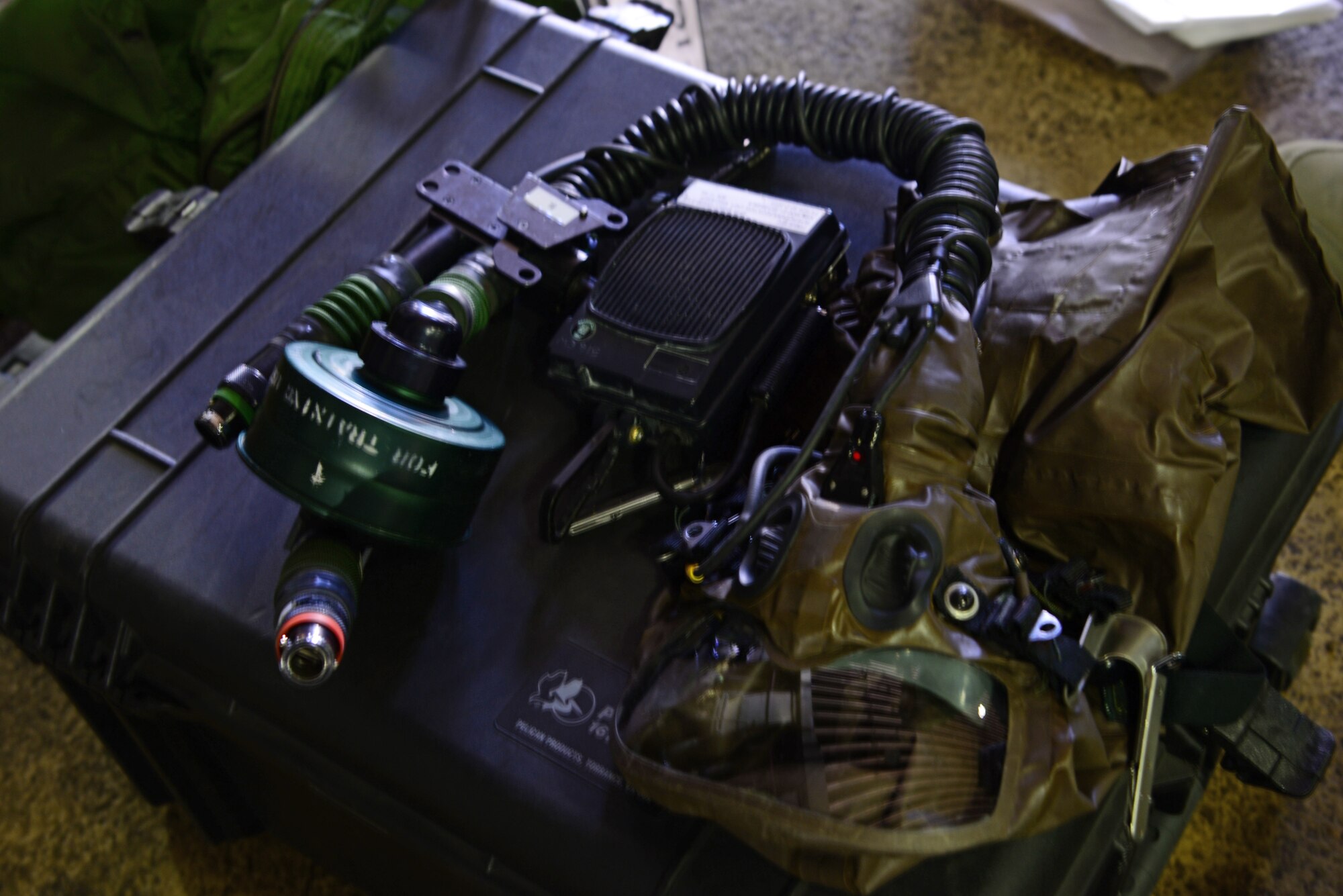 An Aircrew Eye and Respiratory Protection System sits on top of its container box May 4, 2015, at Osan Air Base, Republic of Korea. The AERP system provides aircrew with above the neck chemical and biological protection in the event of an attack during combat. The AERP system includes a hood, MBU12/P mask, C2 filter, an intercom for ground communication and a blower assembly that provides demisting. (U.S. Air Force photo by Staff Sgt. Benjamin Sutton/Released) 
