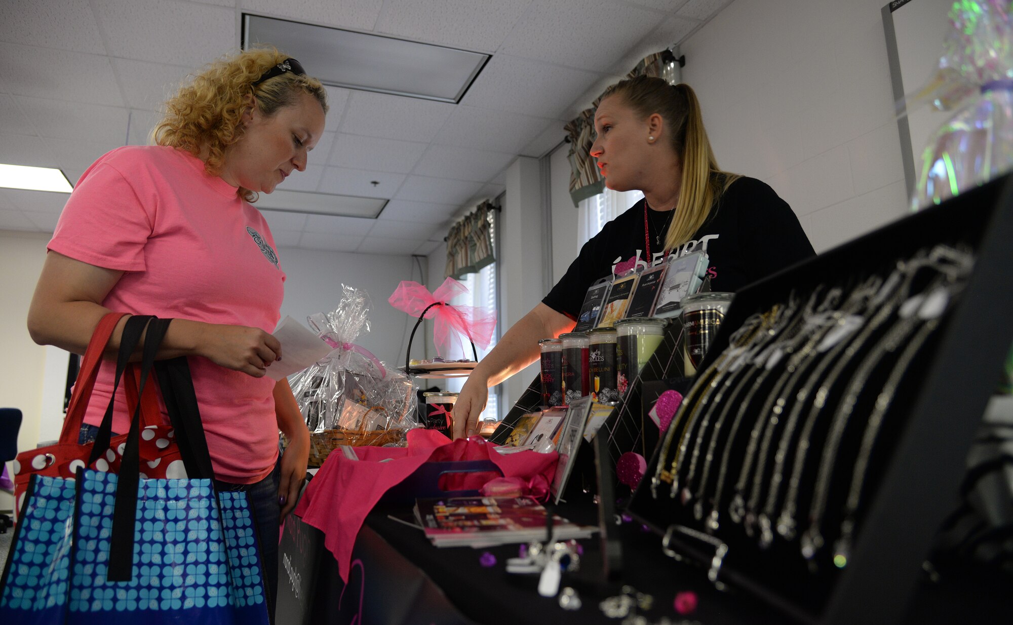 Mandi Pugh,  a local store representative, shows a military spouse candle fragrances at Pamper Me Day, May 7, 2015, Keesler Air Force Base, Miss. Hosted by the Keesler Airman & Family Readiness Center, the event allowed military spouses to receive a day of pampering, including massages, facials, manicures and door prizes. Spouses were also able to learn about the different services offered to them by base entities. (U.S. Air Force photo by Senior Airman Holly Mansfield)