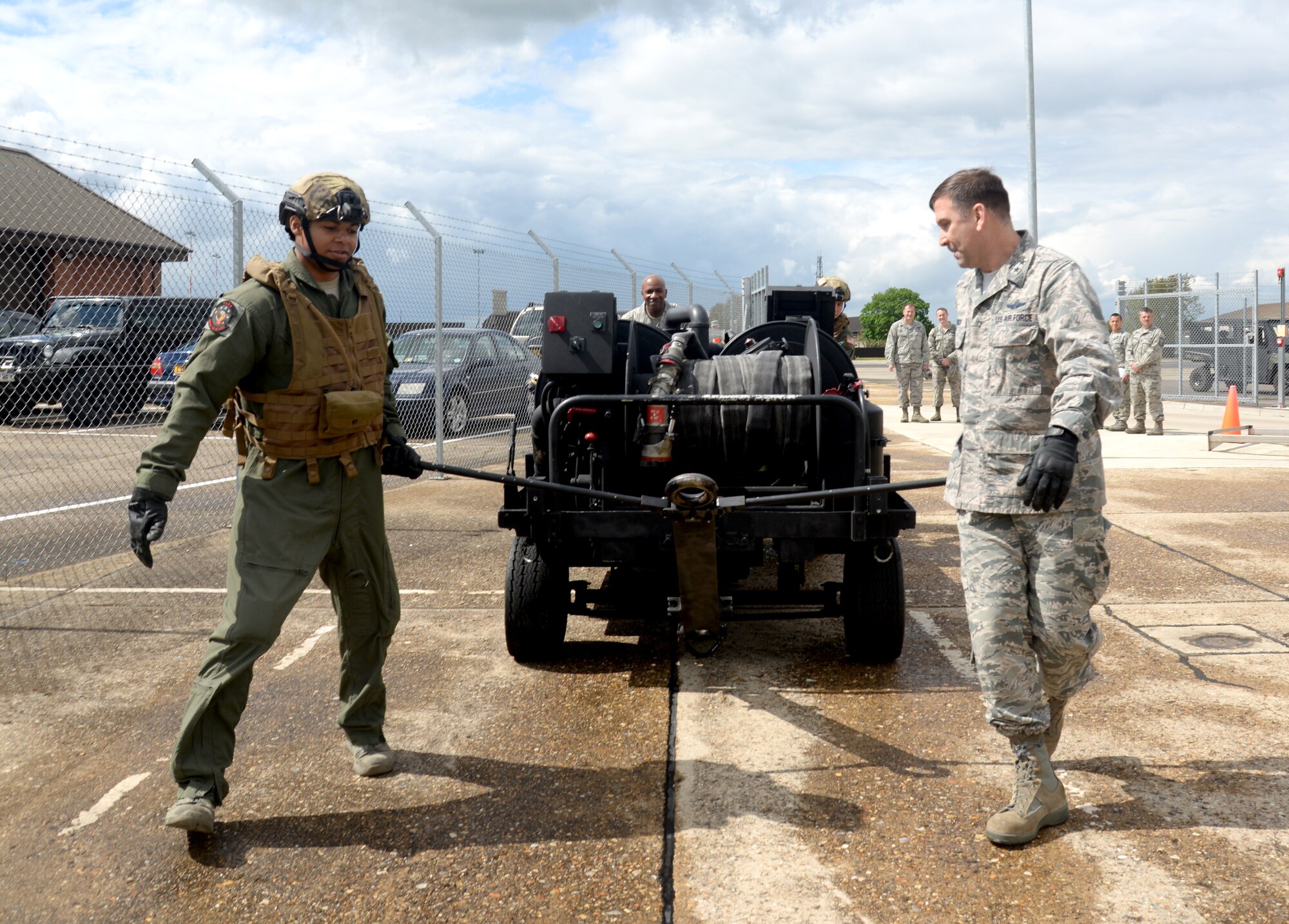 U.S. Air Force Staff Sgt. Anthony Davis, left, 100th Logistics Readiness Squadron NCO in charge of the fuels laboratory and Forward Area Refueling Point hose deployment personnel from Columbia S.C., teaches U.S. Air Force Maj. Gen. Christopher Bence, 3rd Air Force and 17th Expeditionary Air Force vice commander, about FARP operations May 7, 2015, on RAF Mildenhall, England. Aside from speaking to Airmen throughout the base, Bence and U.S. Air Force Chief Master Sgt. Kaleth Wright, 3rd AF and 17th EAF command chief master sergeat, presented Airmen with challenge coins for their accomplishments and hosted all calls for all Team Mildenhall members. (U.S. Air Force photo by Senior Airman Kate Thornton/Released)