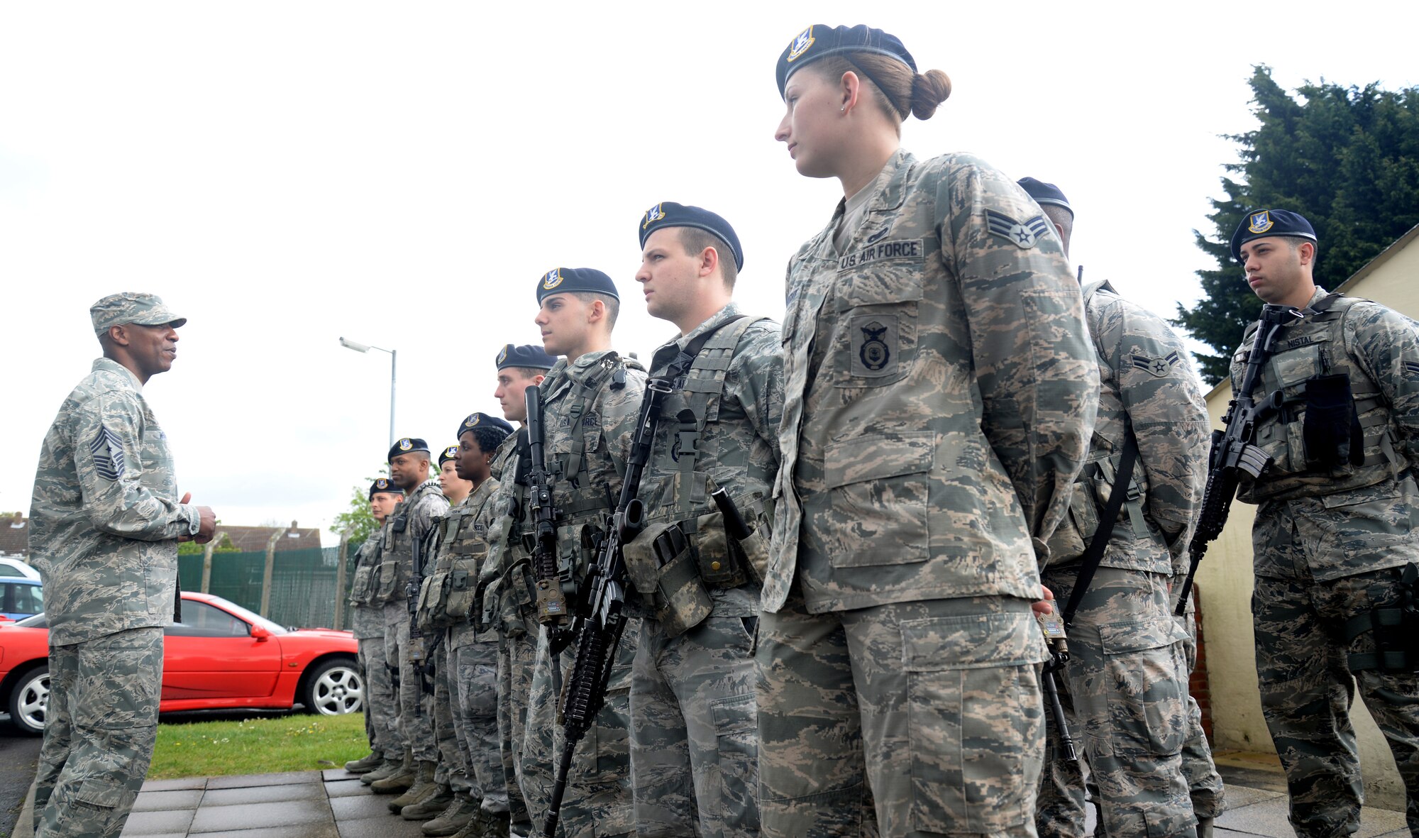U.S. Air Force Chief Master Sgt. Kaleth Wright, left, 3rd Air Force and 17th Expeditionary Air Force command chief master sergeant, speaks to 100th Security Forces Squadron defenders during their daily guard mount May 7, 2015, on RAF Mildenhall, England. Aside from speaking to Airmen throughout the base, Wright and U.S. Air Force Maj. Gen. Christopher Bence, 3rd AF and 17th EAF vice commander, coined Airmen for their accomplishments, toured facilities, learned the mission and hosted all-calls for Team Mildenhall members. (U.S. Air Force photo by Senior Airman Kate Thornton/Released)