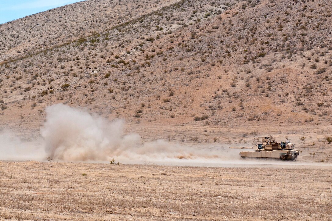 An M1A2 Abrams tank maneuvers through a live-fire exercise in which five tanks advance in formations to engage targets during Decisive Action Rotation 15-07 at National Training Center, Fort Irwin, Calif., April 29, 2015.