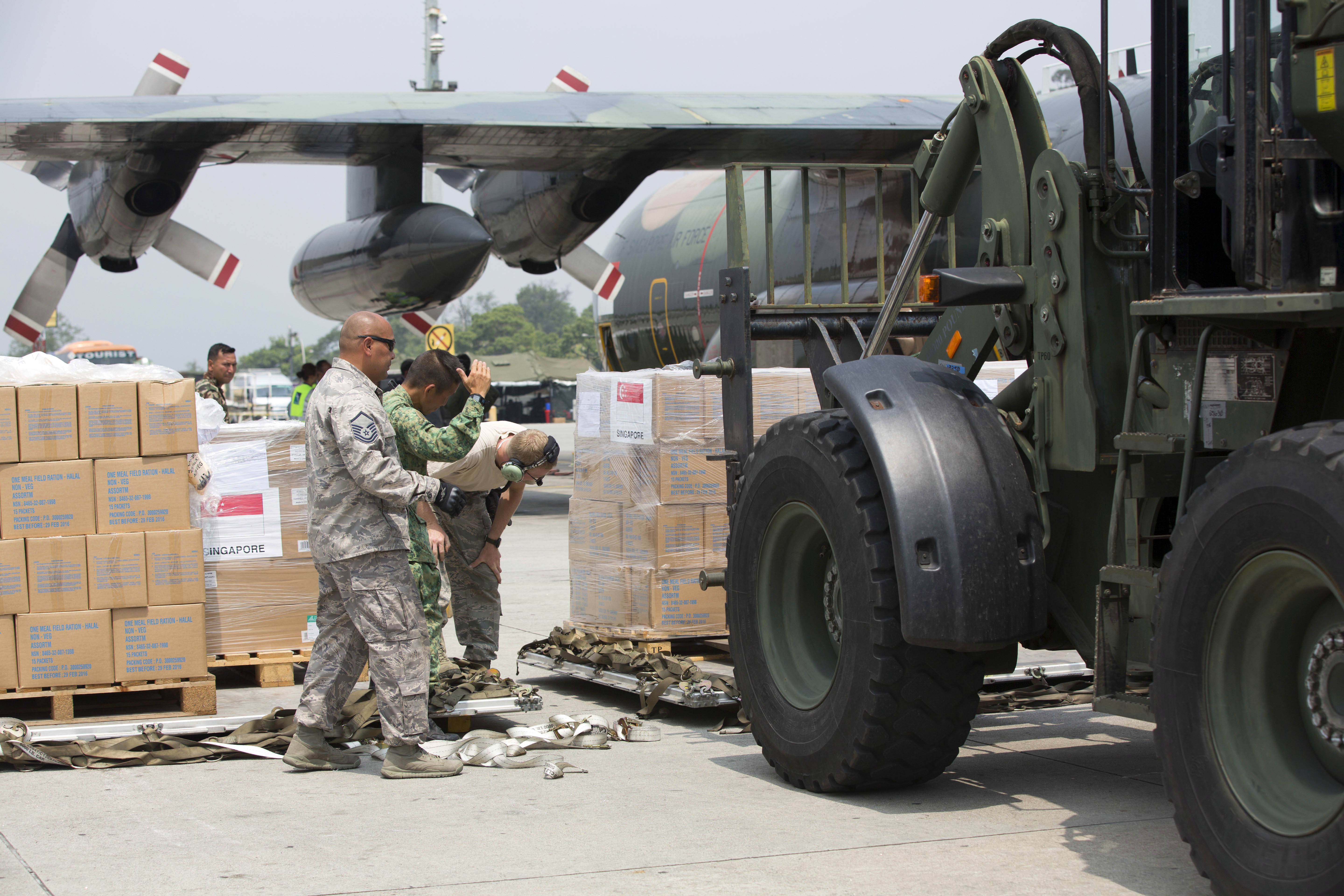 Singaporean And Nepali Soldiers Unload A Singapore Air Force C 130