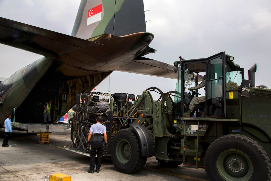 U.S. Air Force Tech. Sgt. Derrick McCall uses a forklift to unload relief supplies from a Singaporean military aircraft at Tribhuvan International Airport in Kathmandu, Nepal, May 9, 2015. McCall is a ramp coordinator assigned to Joint Task Force 505.