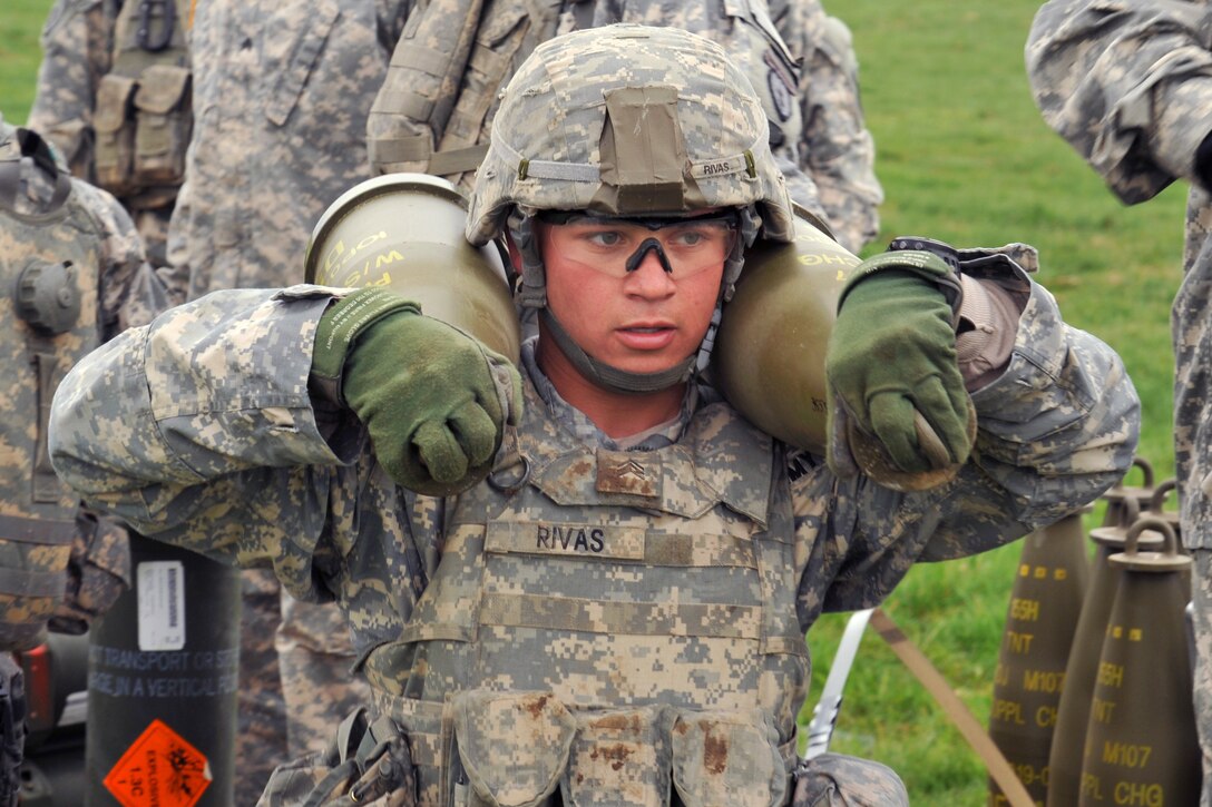 U.S. Army Sgt. Christopher Rivas carries 155 mm rounds for a M777A2 howitzer during a live-fire exercise at the Joint Multinational Training Command's Grafenwoehr Training Area in Germany, April 30, 2015. Rivas is assigned to the 4th Battalion, 319th Airborne Field Artillery Regiment, 173rd Airborne Brigade.