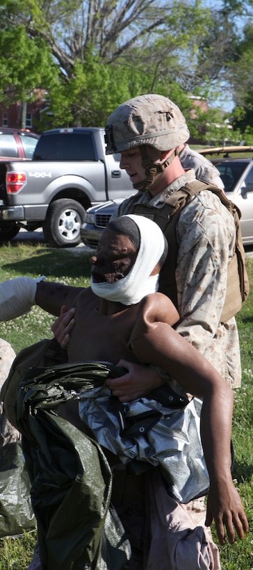 Lance Cpl. Kyle Ward, a mortarman with 2nd Battalion, 2nd Marine Regiment, 2nd Marine Division, drags a simulated casualty to an evacuation site during the final exam for the Combat Trauma Care Course with the Division Combat Skills Center aboard Camp Lejeune, N.C., April 24, 2015. During the test, the Marines were required to run the length of a softball field and reach one of three mannequins. Under the watch of the instructors, the Marines treated the individual wounds on each of the bodies before calling in for evacuation and preparing them for transport. (U.S. Marine Corps photo by Pfc. David N. Hersey/Released)