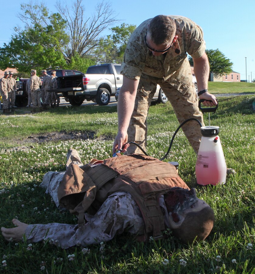Petty Officer First Class David Baumbach, a Navy Corpsman with the Division Combat Skills Center, pumps artificial blood into a mannequin for the Combat Trauma Care class aboard Camp Lejeune, N.C., April 24, 2015. During the week-long course, corpsmen working with the DCSC went over the basics of providing immediate treatment to wounds such as gunshots, hemorrhaging and similar wounds suffered during combat. (U.S. Marine Corps photo by Pfc. David N. Hersey/Released)