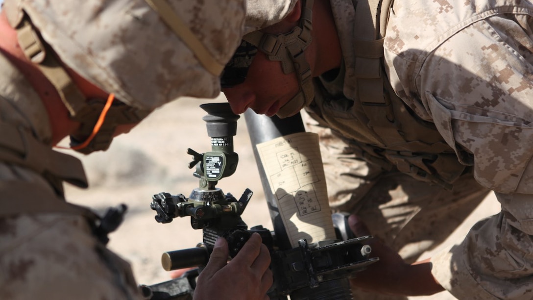 PFC Michael Ainsworth, a mortarman with Weapons Company, 3rd Battalion, 5th Marine Regiment adjusts the sights of the 81 mm mortar system during a combined-arms raid at Army National Training Center Fort Irwin, April 11, 2015. The raid was conducted by 1st Light Armored Reconnaissance Battalion as part of exercise Desert Scimitar 2015.