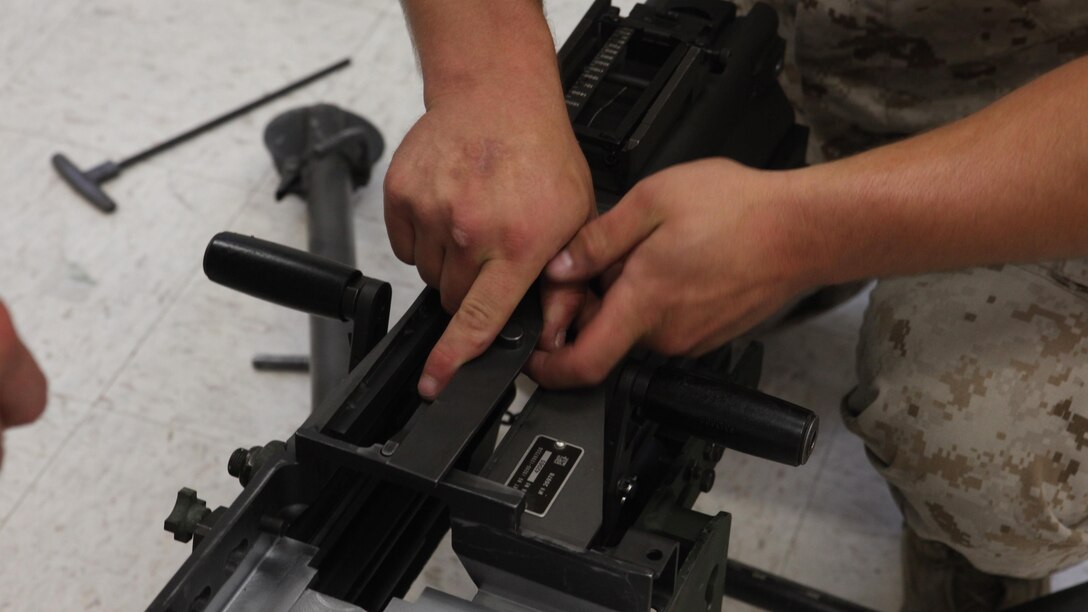 Lance Cpl. Christian Herbeck, a motor vehicle operator with 2nd Light Armored Reconnaissance Battalion, 2nd Marine Division, disassembles a Mk-19 automatic grenade launcher during a Machine Gunners Course at the Division Combat Skills Center aboard Marine Corps Base Camp Lejeune, North Carolina, April 15, 2015. During the course the Marines were trained how to properly disassemble, reassemble and maintain the M249 squad automatic weapon, the M240B machine gun, Browning M2 .50 caliber machine gun and the MK19 automatic grenade launcher. (U.S. Marine Corps photo by Pfc. David N. Hersey/Released)
