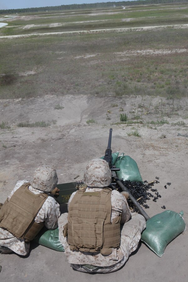 Marines with the Machine Gunner’s Course fire a M2 .50-caliber heavy machine gun during a live-fire exercise aboard Camp Lejeune, N.C., April 23, 2014. Teams of two Marines were assigned to each gun and given 200 rounds with which they were required to accurately aim and strike several targets. An instructor supervised each team, providing instruction and advice when necessary. (U.S. Marine Corps photo by Pfc. David N. Hersey/Released)