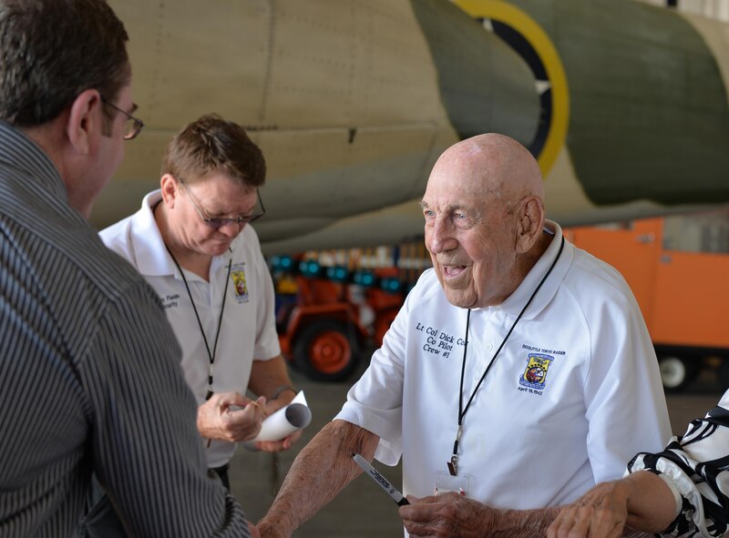 Retired Lt. Col. Dick Cole greets people at the Doolittle Raiders ceremony at Naval Air Station Pensacola May 8, 2015. Cole was standing in front of a B-25 Mitchell, just like the one he flew during the Doolittle Raid.  His aircraft dropped the first American bombs on Japan in WWII.  (U.S. Air Force photo/1st Lt. Ben Sowers)