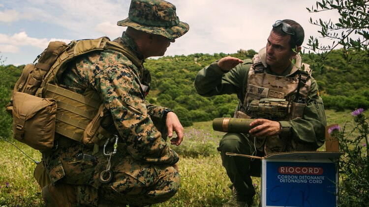 U.S. Marine Gunnery Sgt. Brian Smith, left, an explosive ordnance disposal technician from Special-Purpose Marine Air-Ground Task Force Crisis Response-Africa, discuss their various ordnance disposal techniques with a Spanish Marine EOD technician in Sierra Del Retin, Spain, May 5, 2015. The two groups joined forces for the three-day bilateral training exercise, which was designed to enhance their ability to work as a unified team during future operations. (U.S. Marine Corps photo by Sgt. Paul Peterson/Released)