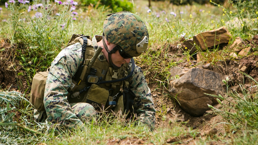 U.S. Marine Staff Sgt. Andrew Cooper, an explosive ordnance disposal technician from Special-Purpose Marine Air-Ground Task Force Crisis Response-Africa, places an explosive charge during ordnance disposal training with Spanish Marine EOD technicians in Sierra Del Retin, Spain, May 5, 2015. The two groups demonstrated their various ordnance disposal techniques for different types of munitions during a three-day training exercise at the range. (U.S. Marine Corps photo by Sgt. Paul Peterson/Released)