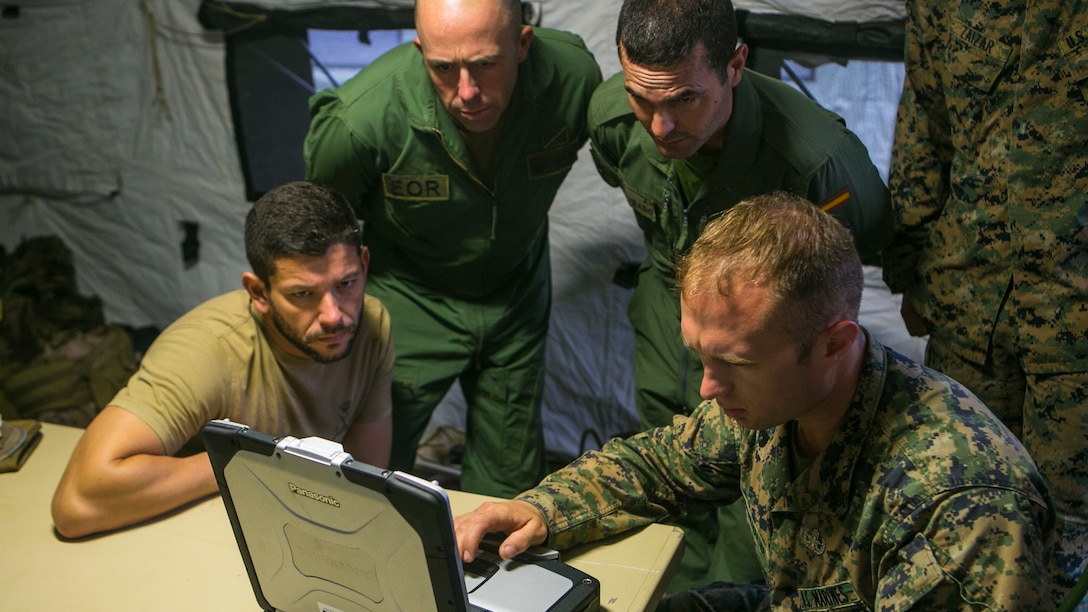 U.S. Marine Staff Sgt. Travis Vuocolo, right, an explosive ordnance disposal technician from Special-Purpose Marine Air-Ground Task Force Crisis Response-Africa, shows Spanish Marine EOD technicians the results of an ordnance x-ray they took during a training exercise in Sierra Del Retin, Spain, May 5, 2015. The two groups worked side by side for three days during a training exercise designed to enhance their interoperability. (U.S. Marine Corps photo by Sgt. Paul Peterson/Released)