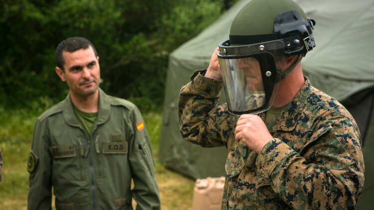 U.S. Marine Gunnery Sgt. Brian Smith, an explosive ordnance disposal technician from Special-Purpose Marine Air-Ground Task Force Crisis Response-Africa, puts on a lightweight Spanish Marine EOD protective helmet in Sierra Del Retin, Spain, May 5, 2015. Smith and other EOD technicians from SPMAGTF-CR-AF joined forces with their Spanish Marine counterparts to share their techniques and procedures and build upon their ability to work together during future operations. (U.S. Marine Corps photo by Sgt. Paul Peterson/Released)