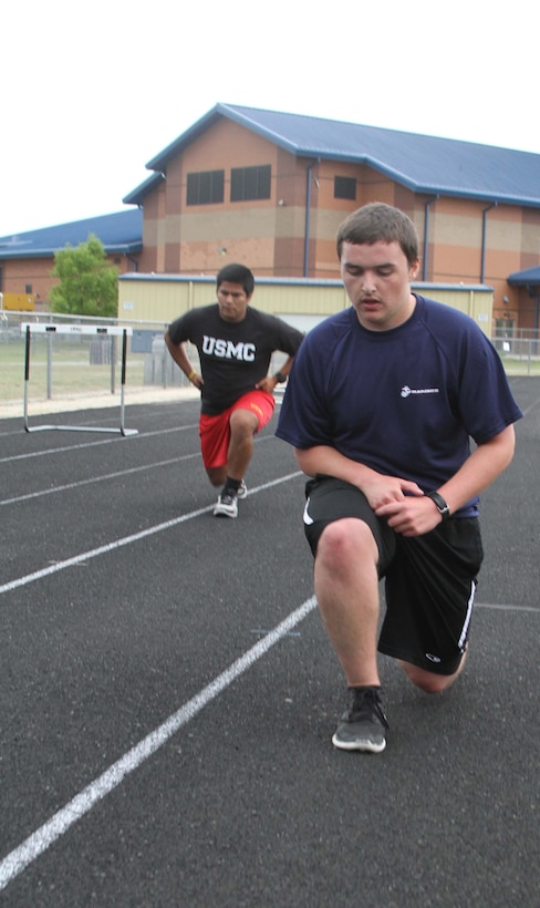 Dylan DeYoung, a poolee with Permanent Contact Station Smithfield, does lunges during a physical training session at Smithfield-Selma High School in Smithfield, North Carolina, April 29, 2015. DeYoung lost more than 70 pounds over the course of 17 months to join the Marine Corps. (U.S. Marine Corps photo by Sgt. Dwight A. Henderson/Released)