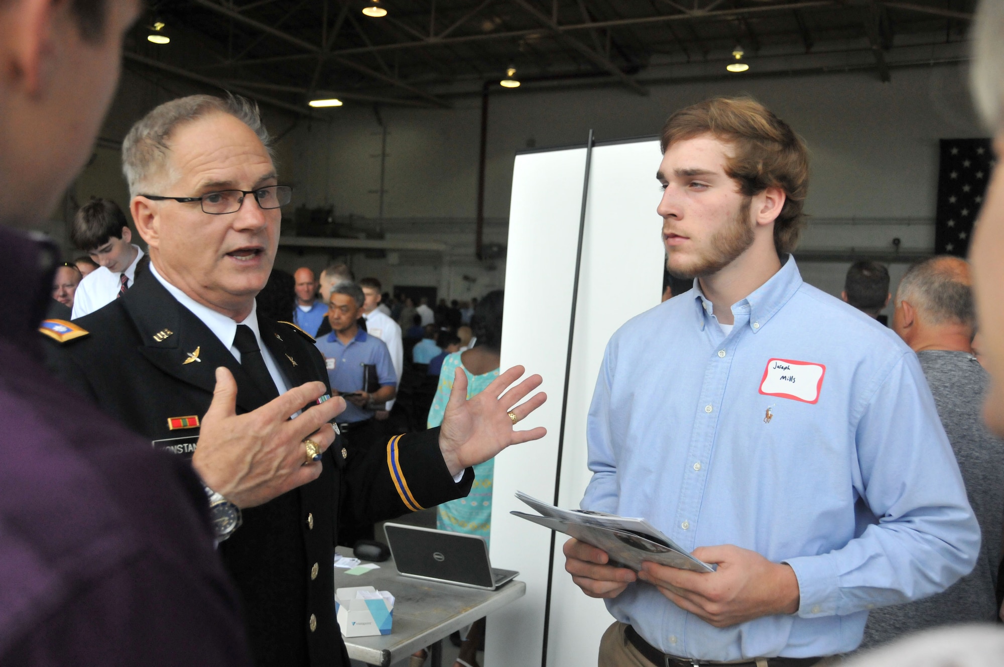A United States Military Academy representative explains to attendees the various programs offered by the US Military Academy for Academy Day in Hangar 5 at Dobbins Air Reserve Base, Ga. on May 9, 2015. The annual event provides high school students the opportunity to meet with representatives from each of the service academies, including West Point, the U.S. Naval Academy, the U.S. Air Force Academy, the Coast Guard Academy, and the U.S. Merchant Marines Academy.  (USAF photo by Senior Airman Andrew J. Park)