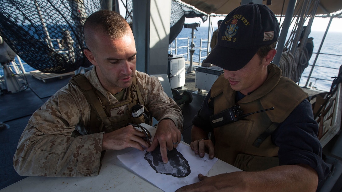 Sergeant Peter Gentry III, left, an anti-tank missileman with Weapons Company, Battalion Landing Team 3rd Battalion, 6th Marine Regiment, 24th Marine Expeditionary Unit, and Mineman 2nd Class Christopher Dunham, assigned to the mine countermeasures ship USS Sentry, identify terrain features of an island they will be passing during the ship’s transit through the Strait of Bab al Mandeb, April 28, 2015. The 24th MEU provided additional small caliber action team capabilities to the USS Sentry during the transit. The 24th MEU is embarked on the ships of the Iwo Jima Amphibious Ready Group and is deployed to maintain regional security in the U.S. 5th Fleet Area of operations. (